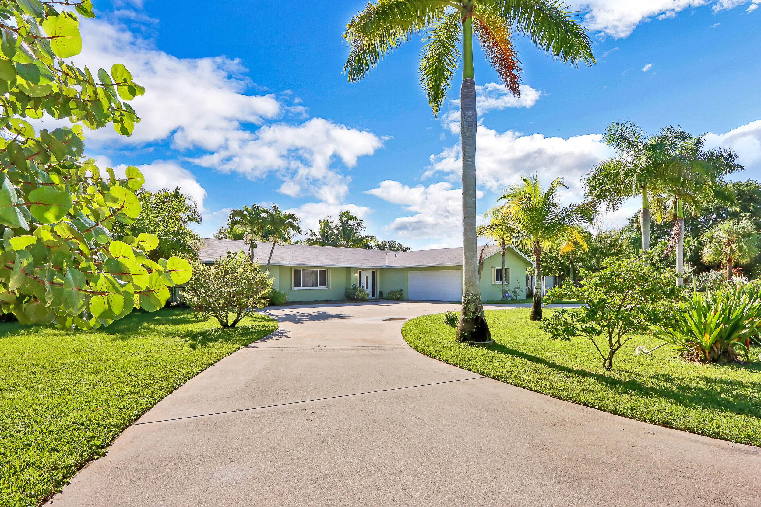 This spacious home offers the perfect mix of privacy, comfort, and outdoor living on nearly an acre east of I-95. The split floorplan includes THREE separate bedroom areas, ideal for families or roommates. The large primary suite features his-and-hers closets and a peaceful view of the backyard and pool. On the opposite side, you'll find three additional bedrooms split into two areas for added privacy. A two-car garage provides room for vehicles and a workbench. Step outside to the covered patio--perfect for relaxing or entertaining--with the inviting pool just steps away!