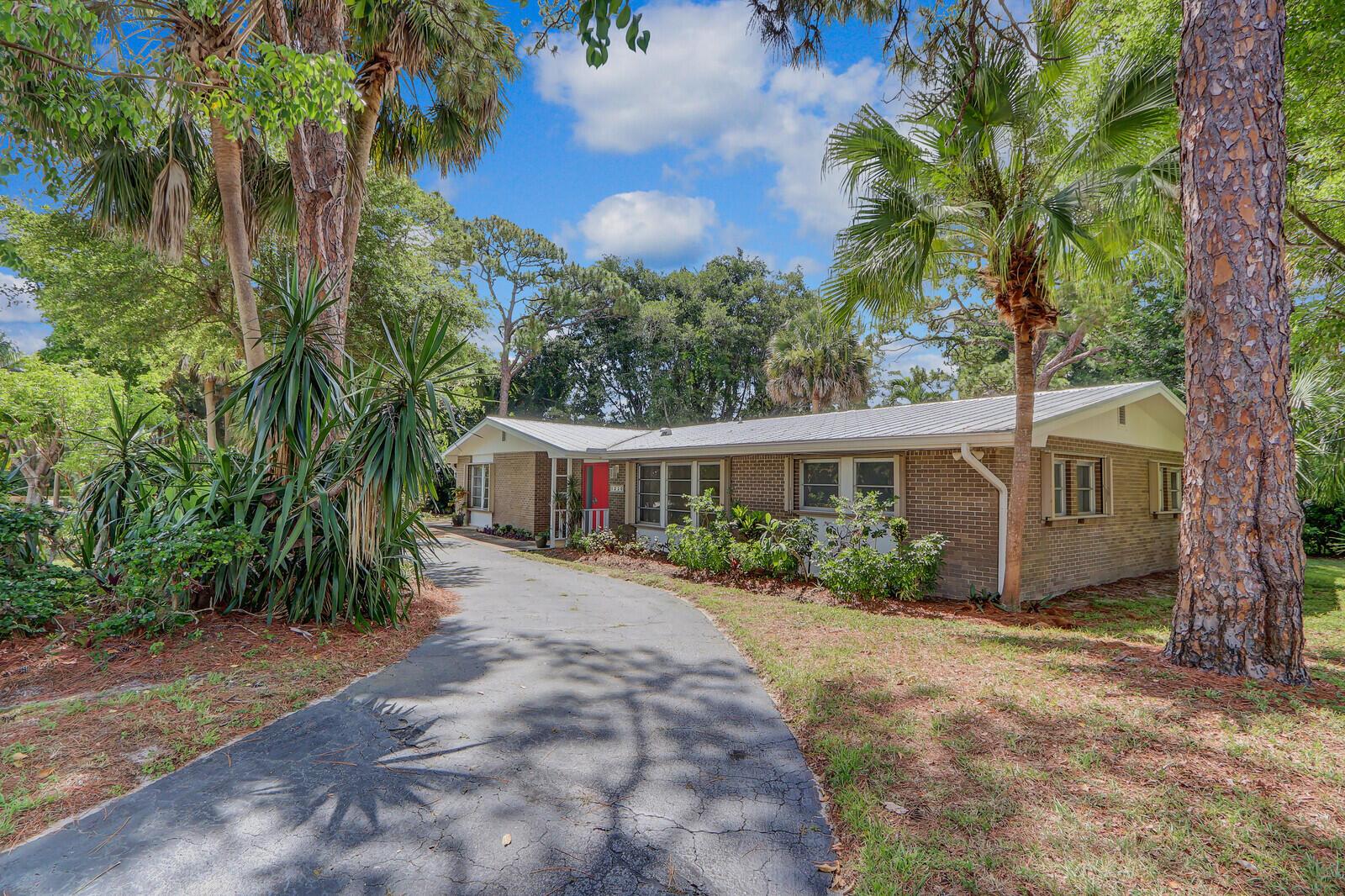 Charming U.S. Steel built 3 bd, 2 bath home with over 2,200 sq. ft. under air in North River Shores. Features split bedrooms, ample closets, and tons of potential. Built in 1962 with a newer metal roof (07/2021). The .496-acre lot boasts lush tropical landscaping including pineapples, papayas, cassava, jicama, bananas, and palms, with room for more plantings and a pool. A U-shaped driveway plus a long driveway leads to the side-entry two-car garage. Optional North River HOA offers park and boat ramp access. Close to beaches, downtown Jensen, and Stuart shops/restaurants. Don't miss this opportunity to own a piece of paradise!