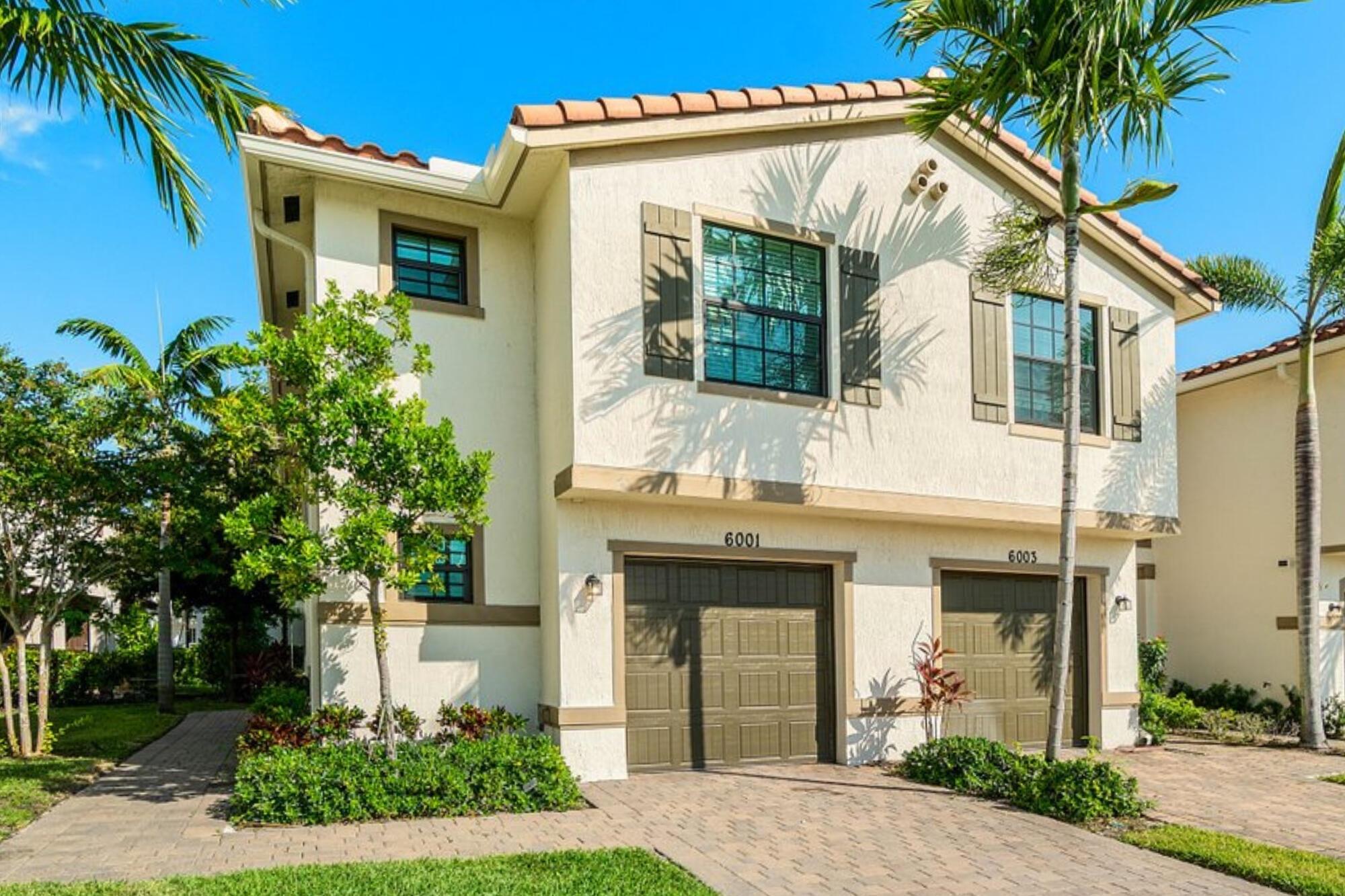 Experience refined living in this 2022-built, three-bedroom, 2.5-bathroom corner-unit townhome, designed for comfort and peace of mind with hurricane-impact windows. The bright, open-concept floor plan features a modern kitchen with white shaker cabinetry, quartz countertops, and stainless steel appliances, seamlessly flowing into the dining and living areas accented by gorgeous flooring and designer light fixtures throughout. Upstairs, all three bedrooms are spacious and well-appointed, with the primary suite boasting a luxurious bathroom featuring a double-sink vanity, a large walk-in closet, and elegant wall paneling.