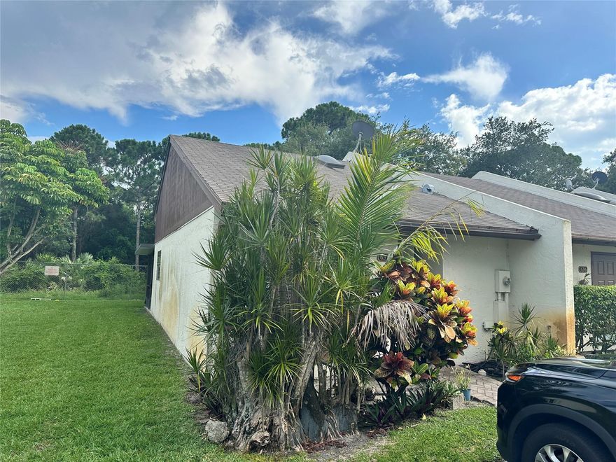 The seller is relocating. Hurry PRICED BELOW VALUE. Fully updated Unit. Perfect 2/2 corner unit with an open plan, updated granite countertops, updated bathrooms, new floors, stainless appliances, split bedrooms, high volume ceilings, with your own parking space in front of the unit. Featuring a large outdoor yard area with a screened and covered patio for your comfort and enjoyment. Brand new Roof 2023, New water heater 2023, New air conditioning System 2023, and brand new window blinds. Freshly painted with new modern 5-inch baseboards and modern. This house is below the price value. Hurry this will not last. Truly a must-see and have.