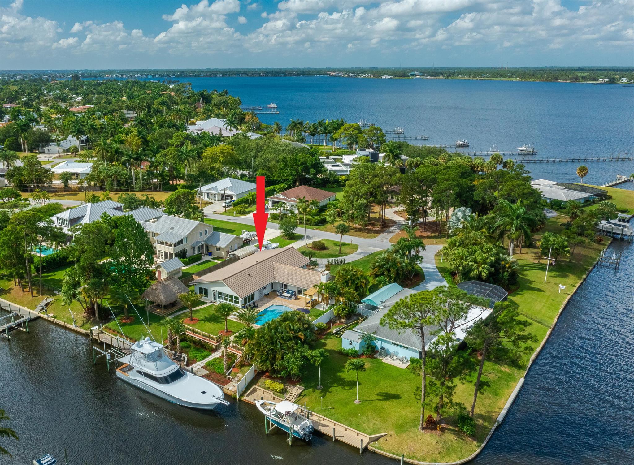 WATERFRONT OCEAN ACCESS & SALTWATER POOL W/ PRIVATE DOCK AND TIKI HUT. Positioned at the St. Lucie River, this beautifully remodeled home is complemented with a modern coastal decor and is fully equipped and furnished for your stay. Whether you're an avid boater or just looking for a gorgeous spot to relax, you're sure to find yourself sunbathing by the crystal clear pool that overlooks a private dock where you can tie up or fish for a variety of species. The dock is equipped with a cleaning station, electric, & water for your watercraft. Relax & swing under the large private Tiki Hut while watching your favorite show & eating your favorite meal fresh off the grill. Currently accepting next season offers Monthly Rates: Off-Season: $8800; Mid-Season:$12K; Season: $16K.(taxes&fees appl