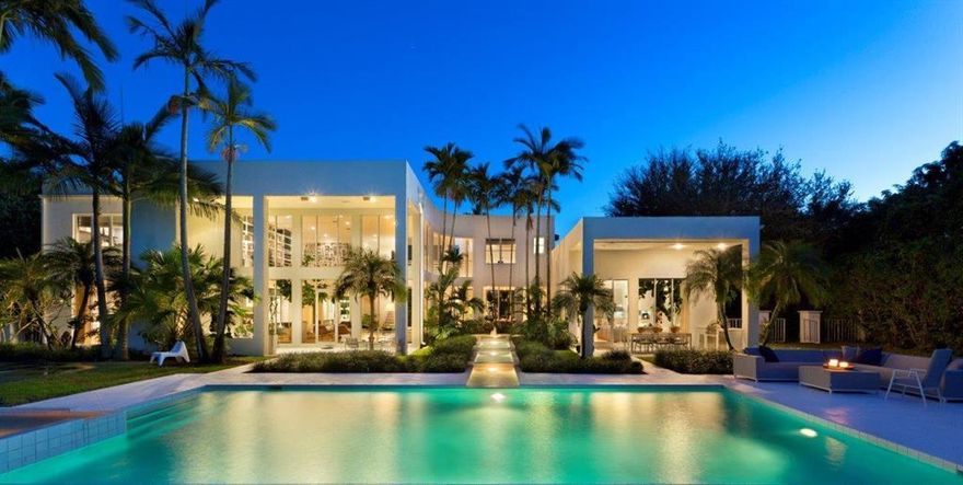 Surrounded by lush tropical landscaping, this rare modern compound enjoys 145+/- of lakefront and almost total privacy. Now featuring 6 bedrooms, 7.1 baths, and 5-garage bays in 13, 212+/- total square feet, this 2-story was reimagined and expanded in 2008 by Studio K architects and crafted by Cudmore Builders providing exceptional water views from all main living areas. Kitchen with stainless steel island, Sub-Zero and Miele appliances and Copat Italian cabinetry; Secluded master suite with 3 walk-in closets, Statuary marble bath with steam shower and Japanese soaking tub, opening onto privacy garden. An office/library, gym, guest wing with separate entrance, theatre/club room, staff quarters, and laundry room complete the first level. Upstairs, a gallery library rims 3 guest suites