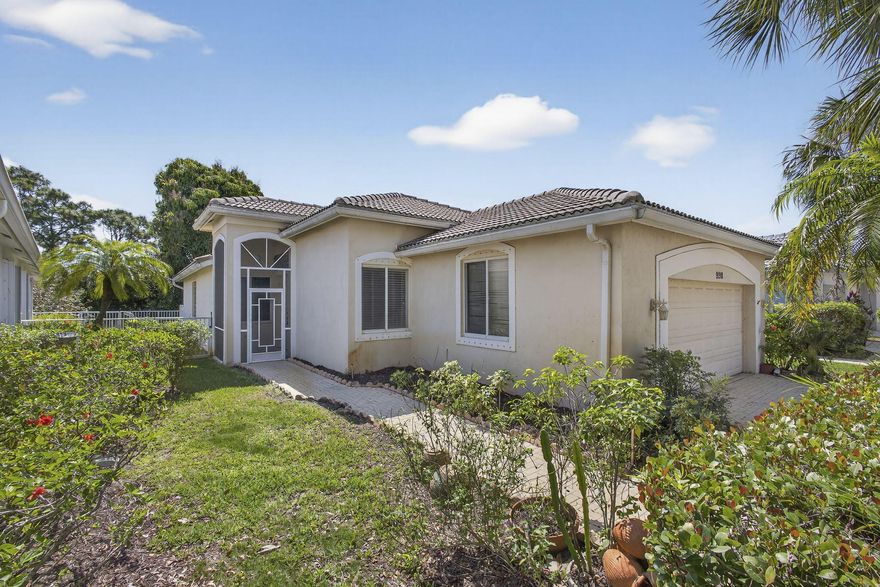 Elegant 3BR/2BA home in the desirable gated Baywinds community. Home has soaring ceilings, tray details, wood floors, custom-built-in media wall, dry bar, and large windows with an open, sun filled ambiance. Kitchen features granite countertops, glass tile backsplash, stainless steel appliances, and large pantry. Great room is open and airy, showcasing the dining and living areas which opens  to a large screened patio with garden views, perfect for entertaining or quiet relaxation. Master Bedroom has high ceilings, walk-in closet, and a tranquil spa-style bathroom. Enjoy resort living with 24 hour manned gate, state of the art clubhouse, heated pools, fitness center, tennis, pickleball, ballroom, social clubs, and endless activities. Near dining, shopping, beaches, golf, & PBI Airport.