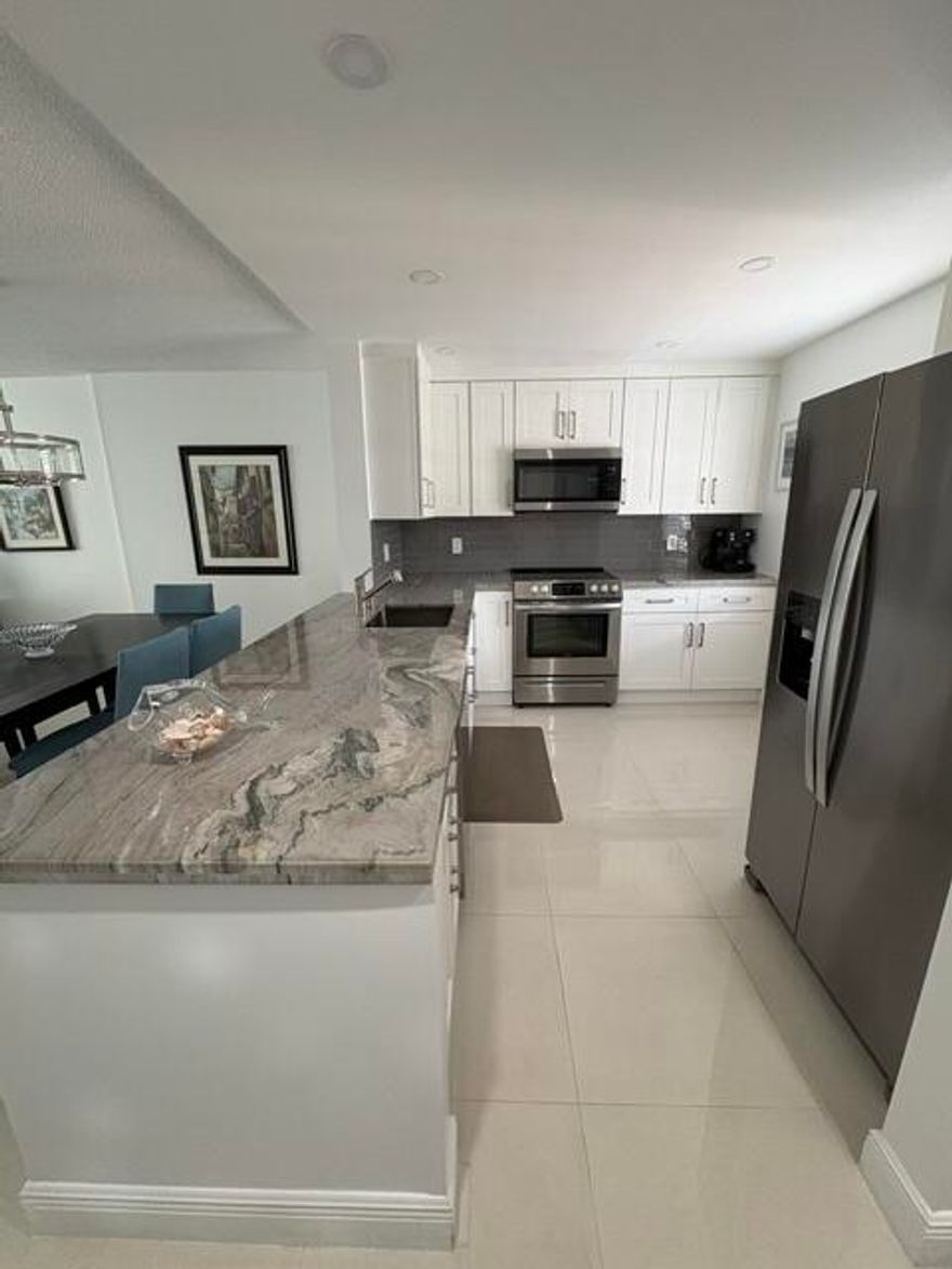 Step into style & comfort in this Move-In Ready, beautifully renovated 2-bedroom/2-bath condo in the heart of Dania Beach! This stunning residence showcases sleek tile flooring throughout  & a bright, modern white kitchen featuring marble countertops & brand-new appliances-perfectly blending elegance w/ easy maintenance. Enjoy peace of mind with major upgrades including a new water heater & new central A/C, while the open-concept layout creates a fresh, airy space ideal for today's lifestyle. Unwind on your screened-in patio overlooking a tranquil lake and sparkling pool! Ideally located just minutes from the beach, shopping, medical offices & major highways, offering both convenience & coastal living at its best.The building has reserves, assessments fully paid & low monthly fees!