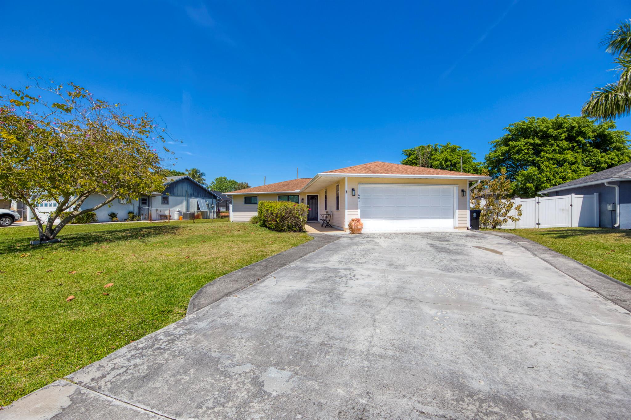 This beautiful 3-bedroom, 2-bathroom home features a stunning pool and hot tub, perfect for relaxation. The home has impact windows in the master bedroom, kitchen, and living room, along with hurricane shutters for added protection. The white fenced yard offers privacy, while Kevlar hurricane screening for the lanai provides extra security. The updated kitchen and bathrooms include new appliances, and the AC unit has also been updated for efficiency. Gorgeous corian countertops add a modern touch to the space. Don't miss the opportunity to make this gem your new home!