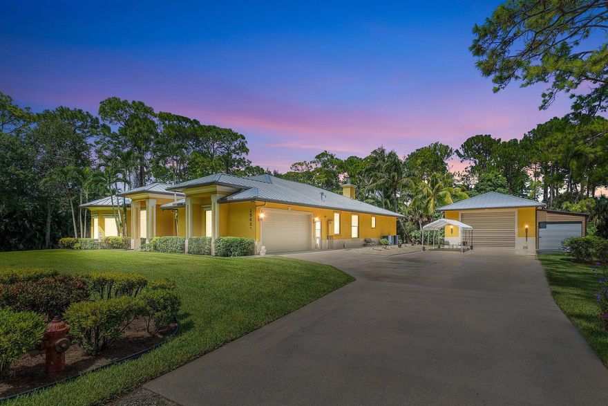 WELCOME HOME This well appointed gem is resting on a premium 2.64 acre lot and boasting 3 bedrooms, plus den, 3 full baths, oversized 624sqft 2 car attached garage, plus a spectacular (1756 sqft) shop, upgrades galore, 2023 metal roof and this beauty is in a superb location! ENTERING the electric gate you will discover that this rare find is resting on the most beautiful Lox land your eyes will ever see, a high and dry fully fenced lot with no pond and a grand covered entry that brings you inside where you are greeted by 12' volume ceilings, high-end flat wall finish, extensive millwork and 8' solid core doors throughout, windows galore, bright and airy rooms, abundance of natural lighting and enormous kitchen that features; newer GE CAFE black stainless steel appliance package, (CLICK)