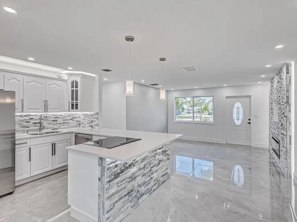 Photo of 855 Date Palm Drive, Lake Park, FL 33403 (MLS # R11167145)