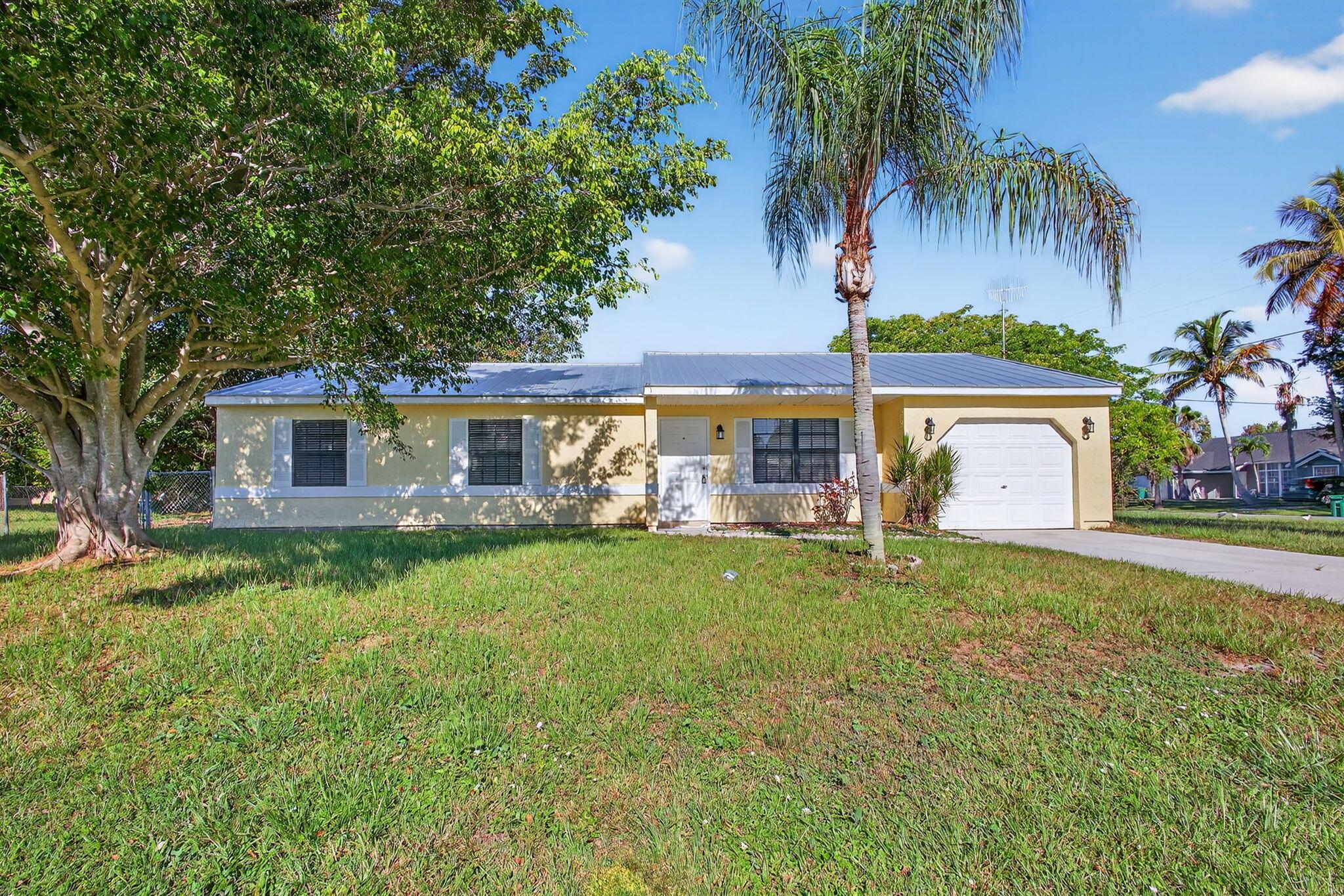 Great opportunity to own this 3 bedroom 2 bath 1 car garage pool home on a large corner lot. Newer metal roof in 2024, plus brand new quartz countertops installed in the kitchen. Tile flooring in the living areas and laminate in the bedrooms. Spacious living room with sliders leading to covered and screened pool area perfect for entertaining. Located close to beaches, restaurants and shopping.