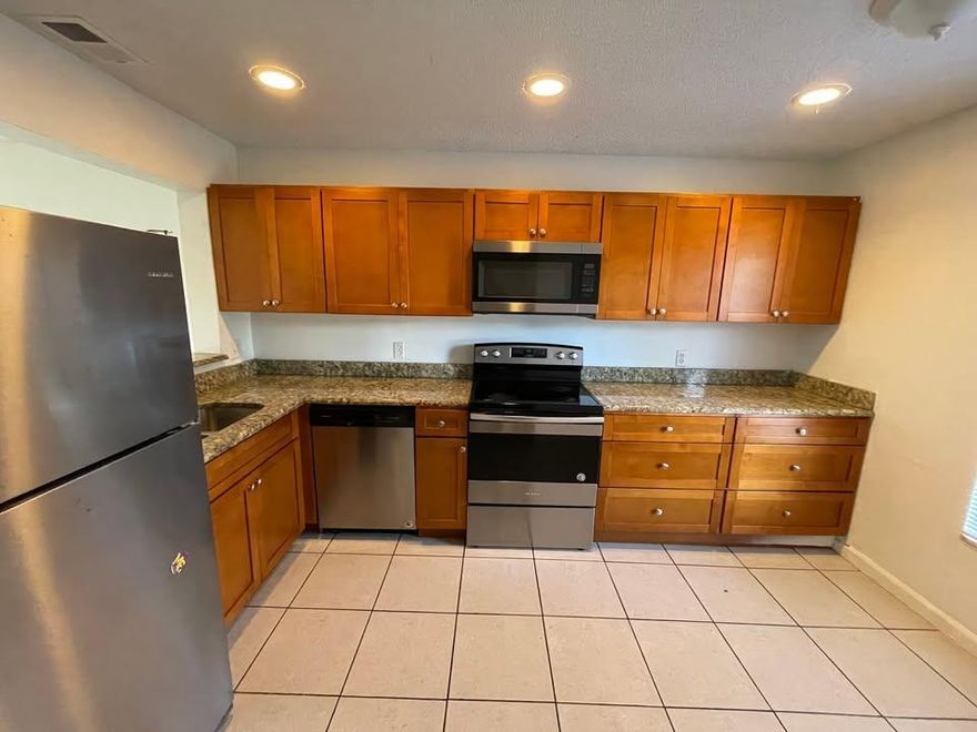 This two-story townhouse, located in a well-established all-ages community in West Palm Beach, is currently part of a portfolio of four investment properties. The townhouse features two bedrooms, one and a half bathrooms, and a spacious living area ideal for tenants or future owners. The kitchen includes hardwood cabinets and granite countertops, offering a modern and functional space.