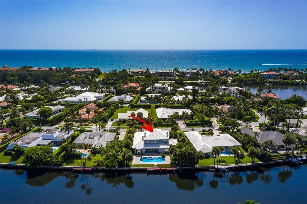 Absolute best value for luxury property in Manalapan! This spectacular 2 story 5 bedroom, 5.5 bath home offers you the best of South Florida waterfront living. Located in a very private area with natural preserve views across the water and your waterfront dock which can accommodate up to a 25' boat, is nestled in the tranquil Intracoastal waters surrounding the Point making for an easy and relaxing ride to the open Ocean. The grand two story entrance foyer sets the stage and welcomes you to an open floor plan bathed in natural light. This spacious home offers dramatic custom lighting, vaulted ceiling and double height walls. You and your guests can move easily from the formal living room with its inviting fireplace.