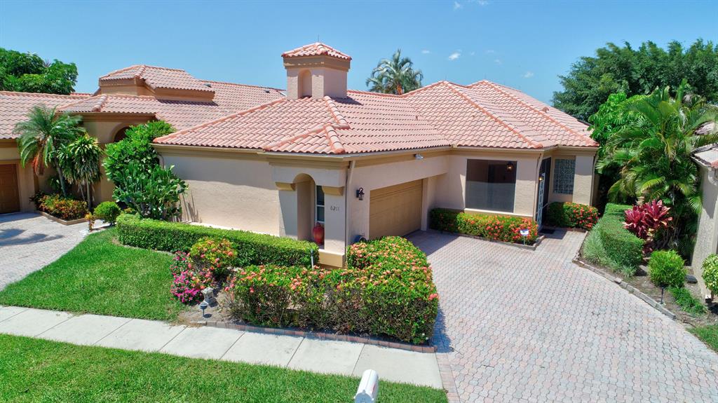 Your 2 bedroom 2-1/2 bathroom Florida home awaits with beautiful panoramic water and golf course view in the Indian Spring Golf and Country Club. Membership is optional in this 55+ young at heart community. The under air wrap around porch guarantees plenty of spacious relaxation assuring you that this is the place you have been looking for and found. Vaulted ceilings and exquisite Turkish Votticino Marble floors greet as you enter. Updated kitchen with granite counter tops and SS appliances. No want for storage with abundant built-ins throughout. Large Master Bedroom, newly carpeted, includes a sitting area. Extra large 2 car garage includes a handy work bench.Take a dip in the pool conveniently located directly across the street.