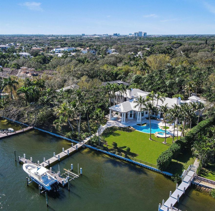 A truly unique opportunity awaits with this exceptional piece of direct intracoastal real estate in the heart of Palm Beach Gardens. Set on an elevated 1.04-acre lot, this expansive, privately gated estate has recently undergone a comprehensive renovation, designed from top to bottom by renowned interior designer Caitlin Kah Interiors, giving it a fresh, new construction feel. Surrounded by meticulously maintained mature oak trees, this remarkable waterfront retreat offers lush green views and optimal eastern exposure for a refreshing breeze. With an extremely rare 180 feet of deep-water intracoastal frontage, the property provides expansive direct intracoastal access.