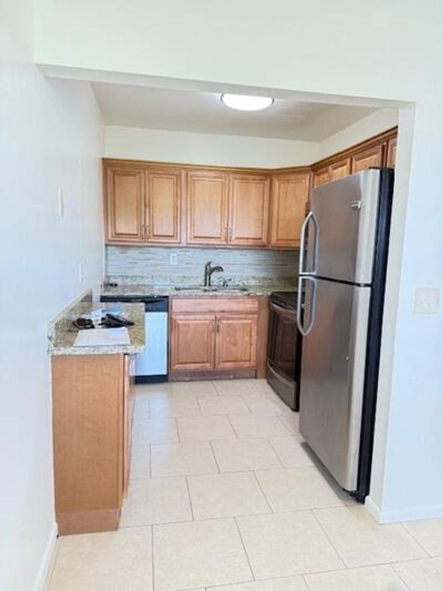 55+ COMMUNITY (HOPA). Beautifully renovated 2-bedroom, 1-bath residence offering refined living in the sought-after Century Village community. This thoughtfully updated unit features a stylish kitchen, elegant finishes, and a bright, comfortable living space designed for easy Florida living. Enjoy a true resort-style lifestyle with an exceptional array of amenities, including a state-of-the-art clubhouse, live entertainment, a 2,000-seat theater, fitness center, indoor pool, and an extensive selection of recreational activities such as tennis, pickleball, and bocce. Complimentary shuttle service provides convenient access throughout the community and to nearby shopping and dining.