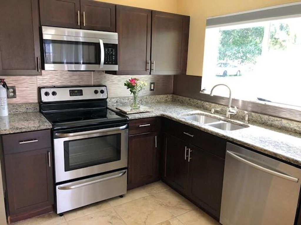 Photo of 413 SW Kentwood Road, Port Saint Lucie, FL 34953 (MLS # R10950706)