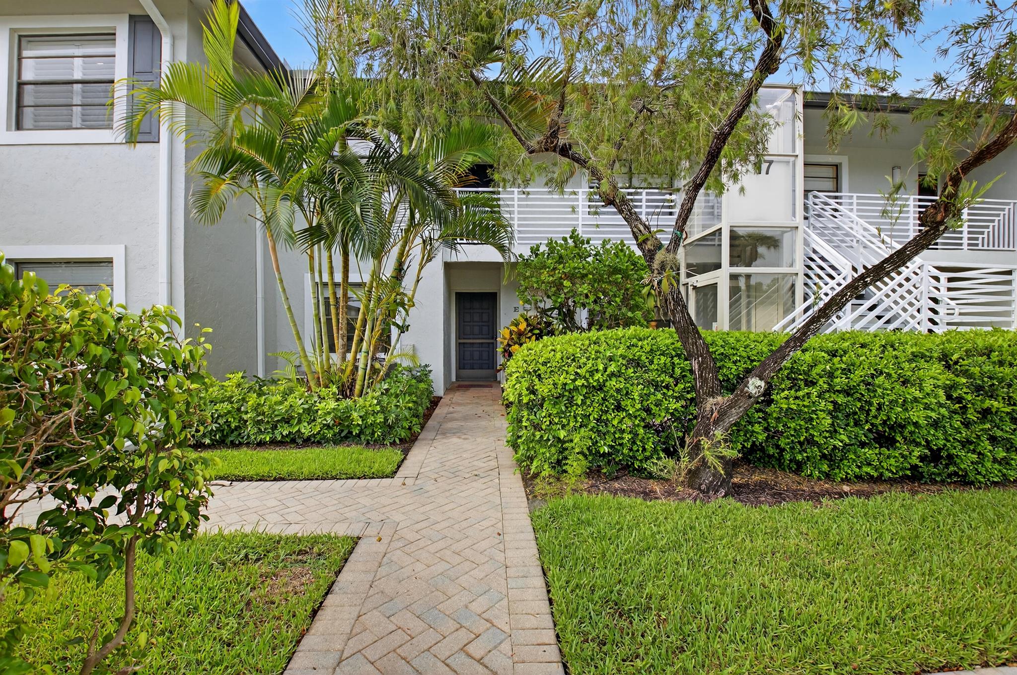 Discover this inviting TOTALLY RENOVATED 2-bedroom, 2-bath condo located in the desirable Hunters Run Country Club. Open Floor Plan, Quartz Counters, Stainless Appliances. LED Lighting Throughout. This light-filled residence offers an open living and dining area, a spacious primary suite, and a screened-in balcony with serene golf and lake views. Custom Pavered Patio For Outdoor Entertaining. Perfect for year-round living or a seasonal retreat, this home provides access to world-class amenities including three championship golf courses, tennis and pickleball courts, resort-style pools, fitness center, spa, and multiple dining venues. Experience the best of South Florida country club living in this beautifully maintained community.