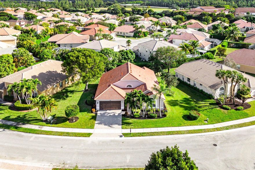 Welcome home to this beautifully maintained three-bedroom, two-bathroom, two-car garage residence located in the desirable gated community of Hamilton Bay. From the moment you arrive, you'll be greeted by lush, mature landscaping and a brick-paver driveway that sets the tone for the care and pride of ownership found throughout the home. Impact sliders and a brand-new roof with a transferable warranty adds peace of mind and long-term value.As you step inside, a split bedroom layout and refined architectural details immediately stand out, including soaring 14-foot cathedral ceilings, updated trim work, plantation shutters, and stylish fixtures throughout. The thoughtfully designed kitchen offers an abundance of counter space accented by sleek black granite countertops, 42-inch