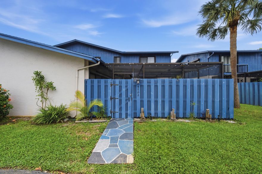 This charming 3-bedroom, 1.5-bath residence features bright and open living spaces. Enter through a private fenced entrance into a spacious screened-in courtyard with electrical outlets—perfect for outdoor entertaining—plus a large storage closet. One bedroom and bathroom downstairs and 2 bedrooms & bath upstairs. Inside, enjoy tile flooring throughout the first floor and a stylish kitchen with granite countertops, new stainless steel appliances, under-cabinet lighting, and a pantry with pull-out drawers. The living area offers 3 large sliding glass doors for seamless indoor-outdoor flow.  Home has fresh interior and exterior paint. Hurricane shutters for peace of mind. Low HOA fee. Centrally located near major roads, shopping, dining, and schools. This home is move-in-ready!