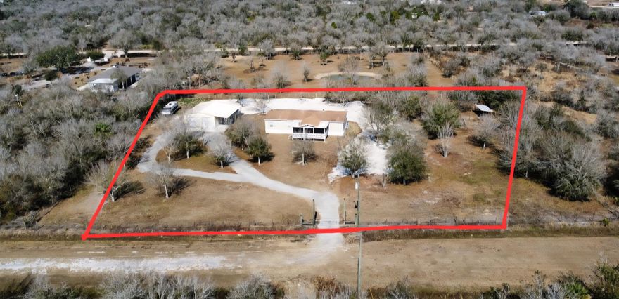 Spacious 4BR/2BA home on 2.5 fully fenced acres offering privacy and space. Well-maintained property with the home centered on the lot. Three bedrooms include walk-in closets, while the fourth is ideal as an office or craft room. Functional interior layout features two separate living rooms, formal dining room, large kitchen, and spacious laundry/mud room. Enjoy outdoor living on the screened-in front porch with vaulted ceiling and TV hookup. Exterior highlights include a quiet road, mature oak trees, expansive yard, plus an additional fenced agricultural area with two pens for animals or hobby use. Steel building garage with two 10-ft automatic doors provides space for 6-8 vehicles, equipment, or workshop use. Peaceful country living with beautiful sunrises and sunsets. Peaceful retreat!