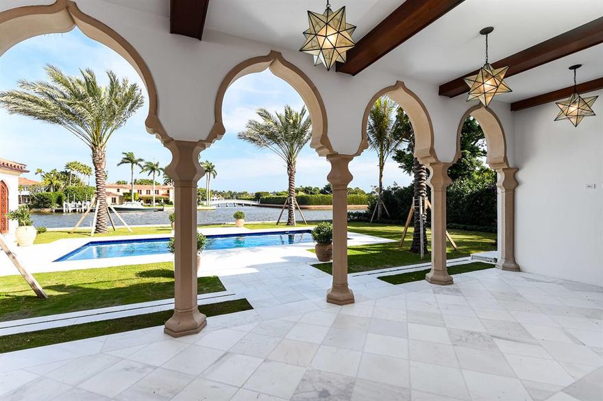 Spectacular waterfront New Construction courtyard home on Everglades Island designed by Smith and Moore. Estate features 7 bedrooms, 7 baths, and two powder rooms. Gorgeous pecky cypress library with fireplace and wet bar. Formal entrance hall with wrought iron curved staircase. Great room with fireplace overlooks Intracoastal. Gourmet top-of-the-line kitchen with butler's pantry opens to waterfront family room. First and second floor owner's suites, elevator, and stunning finishes throughout, including intricate millwork ceilings, elegantly carved stone mantles, and spectacular Moroccan detailing. Fantastic outdoor spaces including tranquil interior courtyard with fountain, several balconies, waterfront loggia, and lakeside pool with cabana. Prime Everglades Island location with gated entry to motor court transports you to your private Oasis. Estimated completion date January 2021.