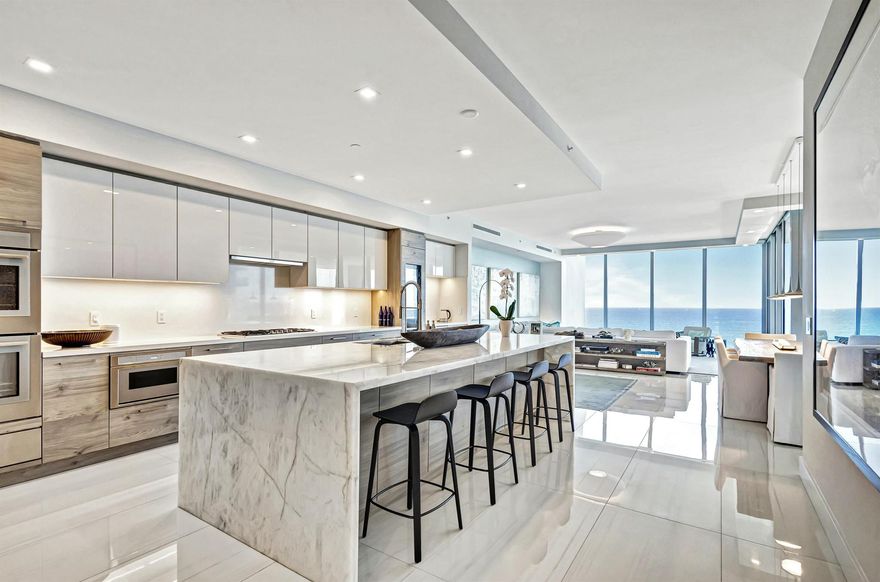 Your Private Beachfront Retreat Awaits! Experience unparalleled luxury in this stunning 3-bedroom + family room, 4.5-bath residence, boasting 3,753 sq. ft. of interior space in the exclusive 5000 North Ocean. As one of just 48 residences in this boutique building, this home offers the perfect blend of sophistication and serenity. Step off your private elevator into a modern, thoughtfully designed space with breathtaking ocean-to-Intracoastal views. The expansive southeast-facing terrace captures direct ocean views and overlooks 340 feet of pristine Singer Island beachfront, while west-facing terraces provide stunning Intracoastal panoramas and vibrant sunsets. Beautifully decorated and offered furnished, this residence is a showcase of modern coastal elegance. The gourmet kitchen features