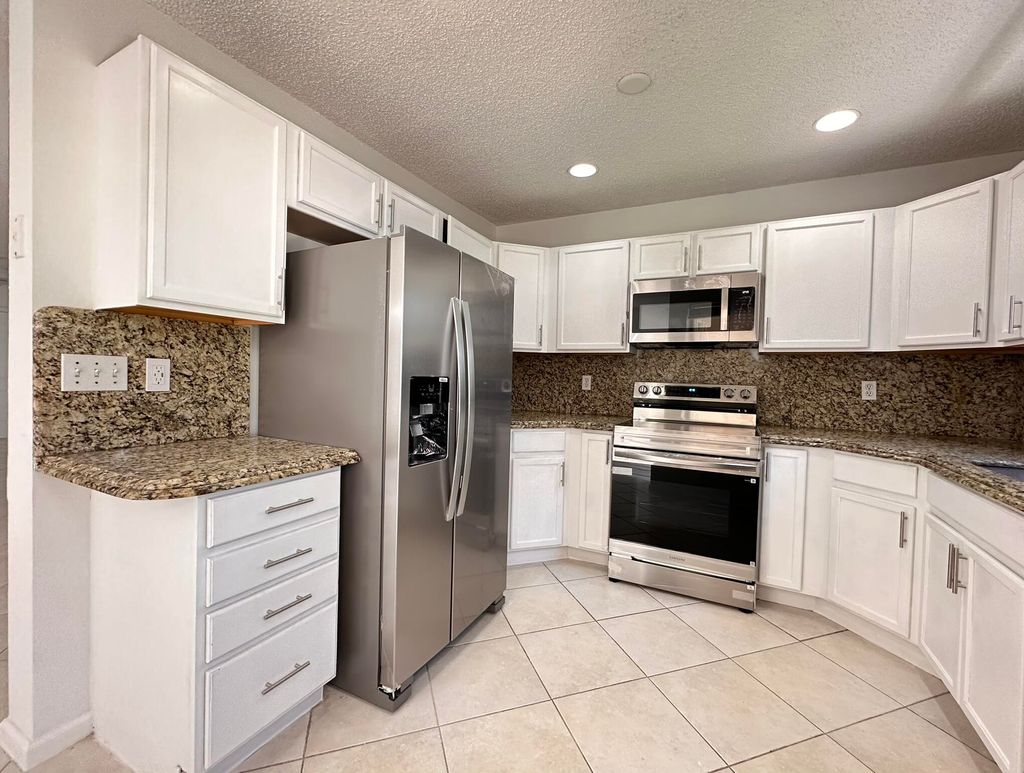 Photo of 703 Crosswinds Drive, Greenacres, FL 33413 (MLS # B26024497)
