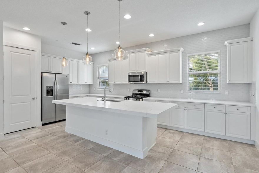 Gorgeous 3 Bedroom +Den/Flex Rm, 3.1 Bathroom, Large 2 Car Garage Lake View Townhouse In the Heart Of ALTON! This TH Exudes White Wood Kitchen Cabinetry, SS Appliances, Beautiful Backsplash, New 3'' White Quartz Kitchen Countertops,3 New Kitchen Drop Down Lights, New Master Bedroom Fixture, Tile Floors Throughout 1st & 2nd Floor. 3rd Floor New Floors (NO CARPET) Frameless Master Shower With White Cabinetry, Large Master Bedroom & XL Walk In Closet. Den/Flex Rm Has Full Bath on 1st Floor. This Home Offers ALL IMPACT WINDOWS & DOORS, Beautiful Blinds, Modern Light Fixtures, Basic Cable/Internet Included & Lawn Care. This Home is Extremely Energy Efficient With Easy Access to I-95 & Florida Turnpike