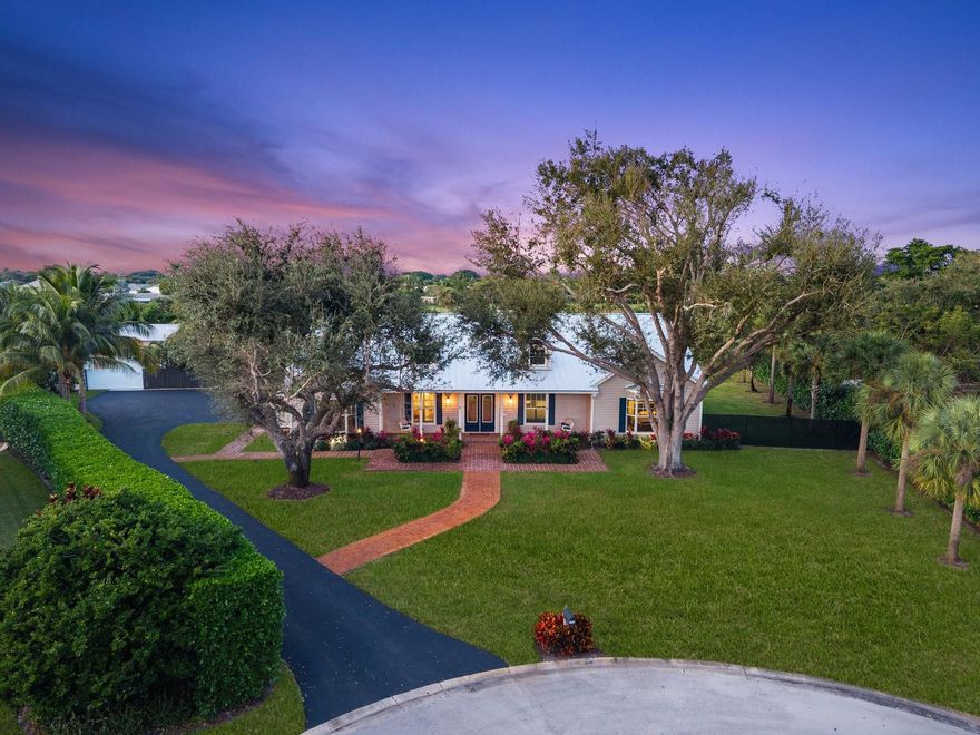 Tucked within coveted Prestwick Estates, this beautiful & perfectly renovated residence blends timeless elegance with modern sophistication. A 2025 metal roof & full impact windows/doors offer peace of mind. 1.06 manicured acres & a welcoming front porch creates striking curb appeal. The light-filled interior features beautiful finishes & views of the resort-style pool. The heart of the home is the great room with a fireplace & the crisp white island kitchen with top-tier appliances & materials. Primary suite has a new spa-inspired bath. Large secondary bedrooms, some with ensuite baths. Backyard offers an oversized saltwater pool with spa, summer kitchen & expansive lawn. A 1,200 sq ft Cat 5–rated garage with office accommodates cars, RV, or boat. Very close to Atlantic Avenue & Lake Ida.