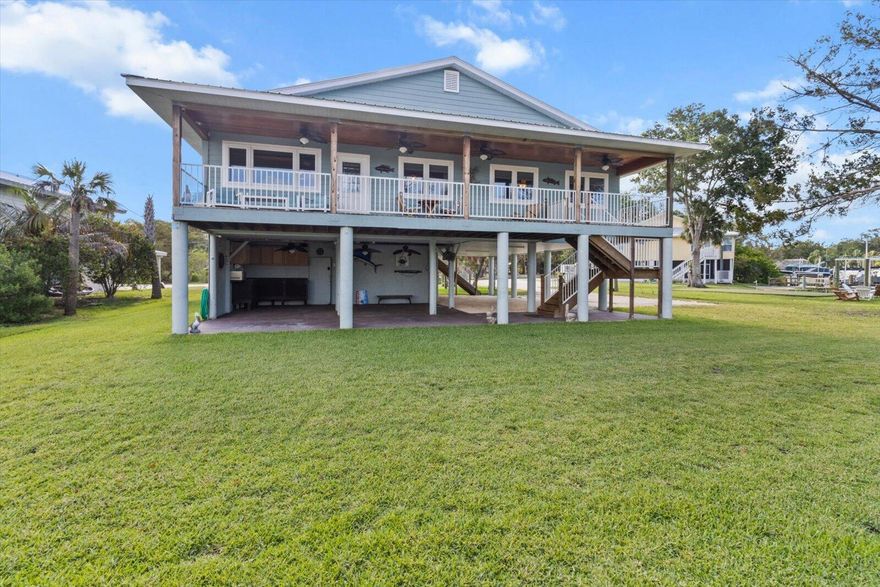 Welcome to your waterfront dream home with River View in the heart of Old Homosassa! This elevated waterfront home offers stunning views of the Homosassa River and includes two adjacent vacant lots, giving you a total of .82 acres of privacy, space, and opportunity. Ride the elevator up and step inside this beautifully maintained elevated home featuring 3 bedrooms and 2 bathrooms, designed for both comfort and style. Large windows flood the home with natural light and provide picturesque river views throughout the home. Enjoy your morning coffee or evening cocktails from your patio deck as boats pass by and manatees make their way down the river. Take a quick boat ride to the GULF or to the blue water springs from your backyard dock equipped with BOTH a boat lift and a boat hoist.