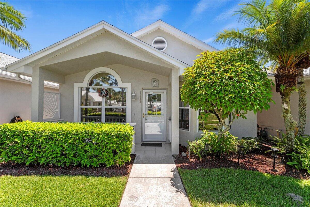 This Highly sought after courtyard villa in the Isle of Lombardy has it all. GORGEOUS LAKE VIEW, SCREENED LANAI, NEW ROOF & COVERED CARPORT. Move right into this adorable 2bd/2ba villa beautifully painted with tile floors throughout. Enjoy the open floor plan with vaulted ceilings. The spacious eat in kitchen offers white cabinetry and white appliances. Extra storage room with full size washer and dryer. The private screened lanai is the perfect place to relax and enjoy the lovely lake views or your front porch overlooking the well maintained courtyard. You will stay busy in this ACTIVE 55+community which offers many social activities, clubs, resort style pool, sauna, gym, billiards, pickleball, tennis and more
