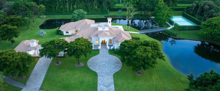 ATTENTION BUYERS WANTING TO BE IN FOR THE SEASON AND SEEKING LAND AND WORLD CLASS SECURITY! Le Lac has been  ranked by Forbes as one of the top 10 gated communities in the country. Le Lac is comprised of only 32 homes nestled on 200 acres with sprawling lawns and sparkling lakes. With privacy a high priority, the entry to La Lac is understated; almost completely hidden from the street. Sited on a totally secluded 4.73-acre lot of professionally landscaped grounds with expansive rolling lawns shaded by mature trees and specimen palms, this peninsula property lives like a private park. With 500 +/- feet of waterfront, its own lake wraps around the residence, making it completely cloistered with no other homes in sight. A storybook bridge leads to the tennis court, and a rustic marble bath meanders to a peaceful meditation garden. In the back are two loggias, one with a fully fitted summer kitchen. Expansive marble terraces surround the newly refinished pool and new marble pool deck.

Truly serene and separate from the hustle of the outside world, this incredible six-bedroom, 10,452± total-square-foot contemporary estate with its own lake is wrapped by 550± feet  of waterfront, offering water views from all the main rooms.  Interiors are defined by large-format designer-curated tile, high decorator ceilings, and custom built-ins. The living room is highlighted by a fireplace with a natural stone surround, a fully fitted wet bar, and a bay of floor-to-ceiling windows offering a panorama  over the pool to the lake and parklike grounds. The handsome paneled library features wainscoting, custom built-ins, a coffered ceiling, and plantation shutters. A highlight in the dining room is a picture window framing a view of the hedged side garden. The gourmet kitchen is fitted with custom wood cabinetry, quartz countertops, professional-grade appliances, a beverage center/coffee bar, a raised island with seating for six, and a breakfast area with banquet seating. The adjoining family room is finished with custom built-in cabinetry and sliding doors accessing  the pool-view loggia and summer kitchen overlooking the lake. The split bedroom plan places three guest-bedroom suites and a den off of the family room. In a wing of its own, the primary suite features a double tray ceiling, built-in cabinetry, designer wallpaper and wood accents. In its sitting area, French doors open to the lake-view pool terrace. The suite also includes two walk-in boutique closets, a gym, and a spa-inspired bathroom with two vanity areas, two water closets, designer soaking tub, huge shower and a private garden. Completing the layout are two more guest bedroom suites, a laundry, a three-car attached garage, and a separate  two-car garage. Renovated in 2023, this unique offering will fit the expectations of the discerning owner who values privacy, the beauty of nature, and stunning contemporary architecture.

DISCLAIMER: Information published or otherwise provided by the listing company and its representatives including but not limited to prices, measurements, square footages, lot sizes, calculations, statistics, and videos are deemed reliable but are not guaranteed and are subject to errors, omissions or changes without notice. All such information should be independently verified by any prospective purchaser or seller. Parties should perform their own due diligence to verify such information prior to a sale or listing. Listing company expressly disclaims any warranty or representation regarding such information. Prices published are either list price, sold price, and/or last asking price. The listing company participates in the Multiple Listing Service and IDX. The properties published as listed and sold are not necessarily exclusive to listing company and may be listed or have sold with other members of the Multiple Listing Service. Transactions where listing company represented both buyers and sellers are calculated as two sales. Cooperating brokers are advised that in the event of a Buyer default, no financial fee will be paid to a cooperating Broker on the Deposits retained by the Seller. No financial fee will be paid to any cooperating broker until title passes or upon actual commencement of a lease. Some affiliations may not be applicable to certain geographic areas. If your property is currently listed with another broker, please disregard any solicitation for services. Copyright 2024 by the listing company. All Rights Reserved.