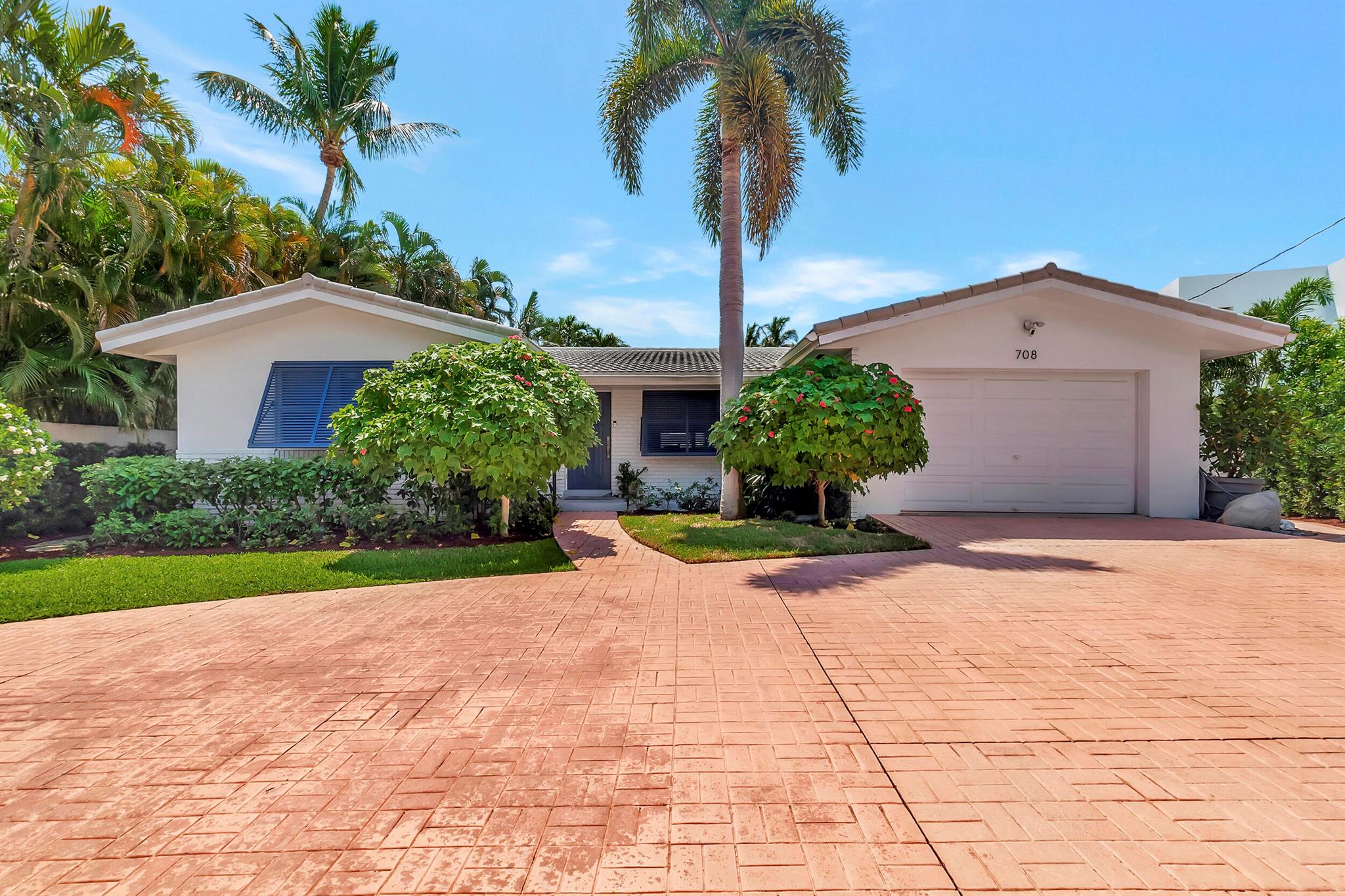 Don't miss this hidden gem! Picture perfect waterfront home set in a private cul de sac. Impeccably landscaped front and back, there's a spectacular yard, deck and dock. Completely renovated inside and out! Using the finest materials and taste. Open quartz kitchen, custom cabinetry, baths, closets nothing left undone. Metal coated roof installed 2006, all impact windows,AC replaced in 2023, water heater 2021.WATER FRONTAGE IS 80'. Can easily take your 50' boat. Ideally located near everything, yet offers tucked away privacy, priceless!