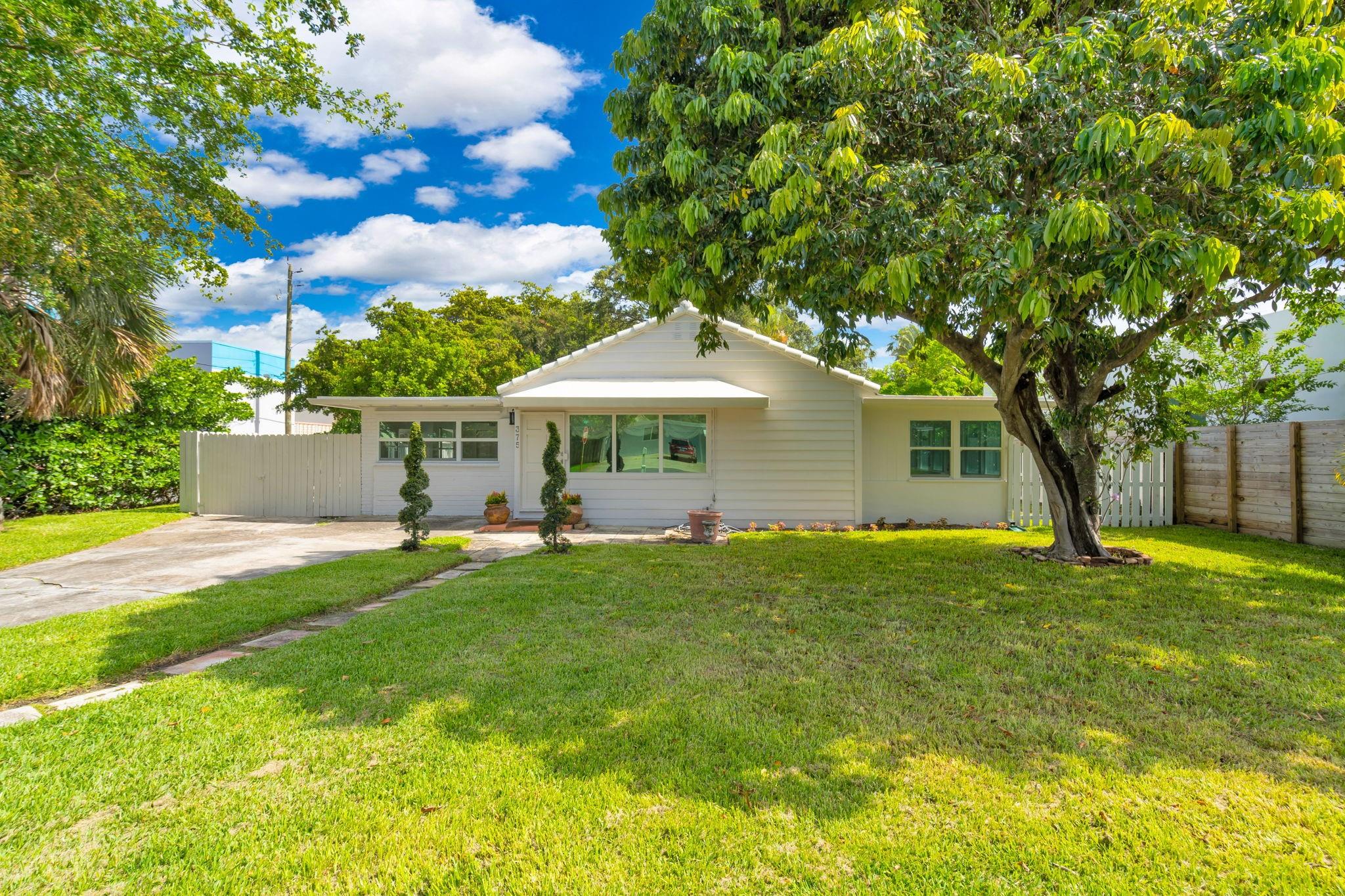 Updated home nestled just a few blocks from the Intracoastal in SoSo! This 4 bedroom, 2 bathroom home is in the heart of Southend very close to the new pickleball courts. The home is tiled throughout and updated with partial impact windows. Light and bright sunroom doubles as a flex space and can be whatever you imagine. One bedroom serves as a walk through nursery or office with another bedroom having an exterior door. The back yard is big enough for a pool with multi million dollar homes lining the street and neighborhood. This gem is turnkey enough to move in or a great sized lot to build your own multi-million dollar estate. Home has chic upgrades including a herringbone design Italian tile and travertine floors. The yard is fenced and includes olive and lychee trees.