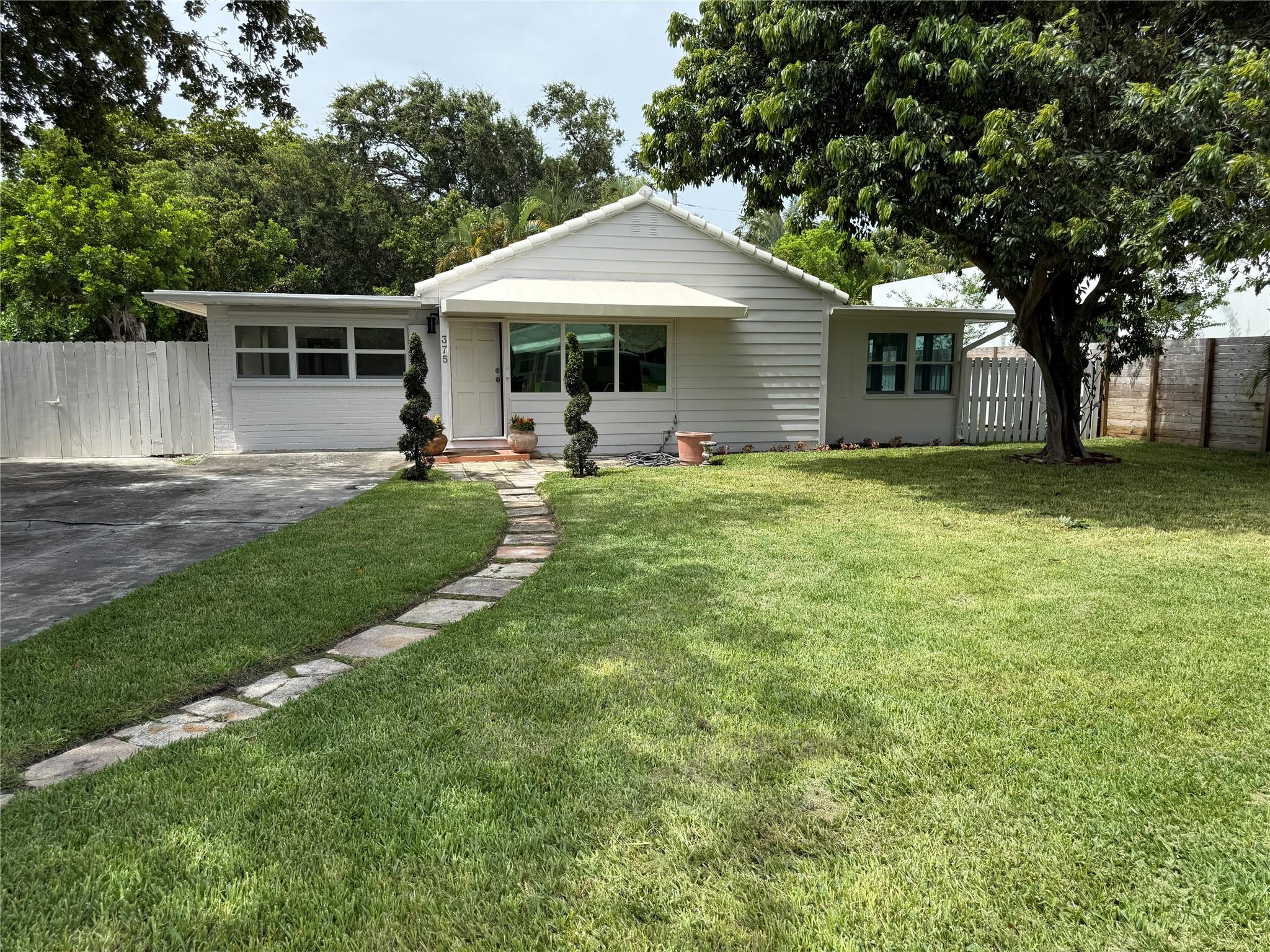 Updated home nestled just a few blocks from the Intracoastal in SoSo! This 4 bedroom, 2 bathroom home is in the heart of Southend very close to the new pickleball courts. The home is tiled throughout and updated with partial impact windows. Light and bright sunroom doubles as a flex space and can be whatever you imagine. One bedroom serves as a walk through nursery or office with another bedroom having an exterior door. The back yard is big enough for a pool with multi million dollar homes lining the street and neighborhood. This gem is turnkey enough to move in or a great sized lot to build your own multi-million dollar estate. Home has chic upgrades including a herringbone design Italian tile and travertine floors. The yard is fenced and includes olive and lychee trees.
