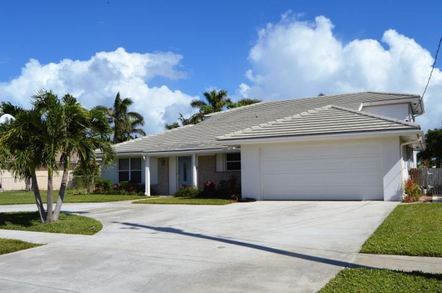 Beautiful Juno Isles waterfront home with circular driveway. 4 Bed/ 4 Bath 2 story with Ocean and Intercoastal Access. 1 FIXED BRIDGE & 1 Lift,Dock, seawall. Wonderful pool with  waterfall. New AC & Hot water Custom Downsview Kitchen features Thermador cooktop, Sirius hood, Miele steaming drawer, and 48'' Kitchenaid refrigerator. Italian marble floors throughout first floor. Theater room fully equipped with tv/surround sound/2 rows of stadium seating/2 sub zero wine coolers. Walk in closets, 4 custom bathrooms, built in custom cabinetry in dining & living areas, 2nd floor loft area. **$5000 boat lift stock certificate included** https://junoisles.org/site/ *new fence,