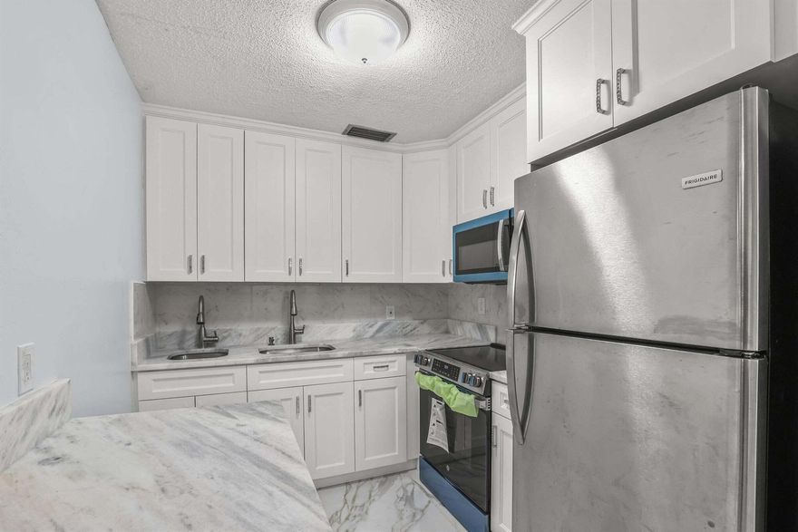 WOW! MUST SEE UPDATED 2 BEDROOM 1.5 BATH CONDO IN THE SOUGHT AFTER HASTINGS ASSOCIATION. STUNNING KITCHEN WITH WHITE SHAKER CABINETS,GRANITE COUNTERTOPS NEW STAINLESS-STEEL APPLIANCES.2 SEPARATE SINKS NEW TILE FLOORING, RECESSED LIGHTING AND CENTRAL AIR CONDITIONING.NEUTRAL COLORS THROUGH OUT UPDATED BATHROOMS. GREAT ASSOCIATION NEW ROOF COMING AND NO ASSESSMENT STEPS TO THE HASTINGS FITNESS CENTER WHICH HAS RESISTANCE POOL, SWIMMING. POOL , SAUNA AND GYM.  COME & ENJOY RESORT STYLE LIVING IN THIS GATED COMMUNITY FOR ACTIVE ADULTS 55 +. CLUBHOUSE features a theater, indoor pool, card room, community/party room, billiard room ,shuffle board ,tennis , pickleball ,bocce and two outdoor pools. Numerous heated outdoor pools throughout the community. Two guarded gates and 24 hour roving securit