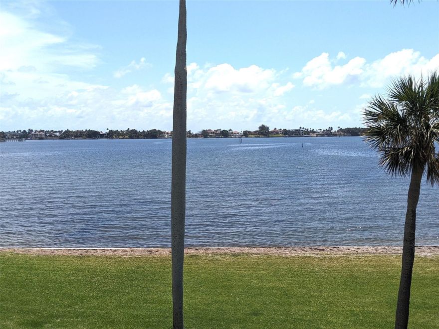 Welcome to the Most Beautiful -  Totally Updated - Intracoastal View Condo! Washer/Dryer/ Sprinklers. Custom Lighting and Fans.   Covered Parking - Large Balcony overlooking Wide Water Views. Remote Control Shades all Window/Sliding Door with wide plank grey tile floors and Blue Sky Cambria Quartz Kitchen counter tops  - Card Room, Pickleball and Tennis Courts, Kitchen, Kayak/Paddle board Storage Rack.  On-Site manager and Maintenance Person. Private Sandy Beach !!! Hurricane Glass Windows in Bedrooms Sliding Door in LR to Patio/and shutters for doutble protection.