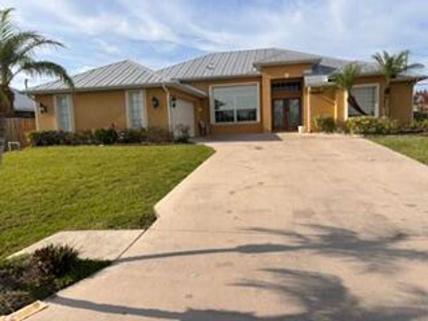 Don't miss this opportunity to own an oversized corner lot, CBS home in the most sort out location of St. James area. Surrounded with newer and well-maintained homes. A 3/2 with extra den or office can be converted into a 4th bedroom. Vaulted ceiling, with open split floor plan. The living area has a built-in entertainment center. Perfect for family and entertaining. Dining & family game area are open to a gourmet kitchen and a cozy kitchen nook. Stainless steel appliances, double wall oven, tile backsplash and granite countertops throughout. 42" cabinet with under cabinet lighting including large island. Large master bedroom has tray ceilings, his & hers walk in closets; two vanity sinks, roman tub with separate shower. Hurricane impact glass sliding door to patio. See supplement remark.  Second bedroom is located at the back of the house, has a large cabana bathroom & a combo tub/shower with seamless glass doors; has its own walk-in closet, sliding glass door to backyard. Third bedroom is private with its own window seat. Den is next to Cabana bathroom with a door which can easily be a fourth bedroom. Spacious laundry room includes  front load washer and dryer, built in ironing board, and wash sink. All windows & doors are solar tinted to help with energy efficiency & hurricane shutters for entire home; The two-car garage has an automatic door with openers. This beautiful home has an intercom/music/alarm system. Outside the home enjoy your peaceful backyard on your spacious 34x8 patio with screen enclosure, wired for TV. Room for a Pool. Complete gutters all around.  All lighting, fans, and blinds are included. All hurricane accordion shutters installed 2021 on all windows and doors including patio. Water heater 2021, Metal Roof 2015, A/C 2014. Tile in living area and laminated floors in all bedrooms. An extra side driveway for Boat or RV. Across the street take a walk along the canal or go fishing. This well-kept, spacious home is ready for you to call home. Don't wait long before you lose out!!! It's a must see!