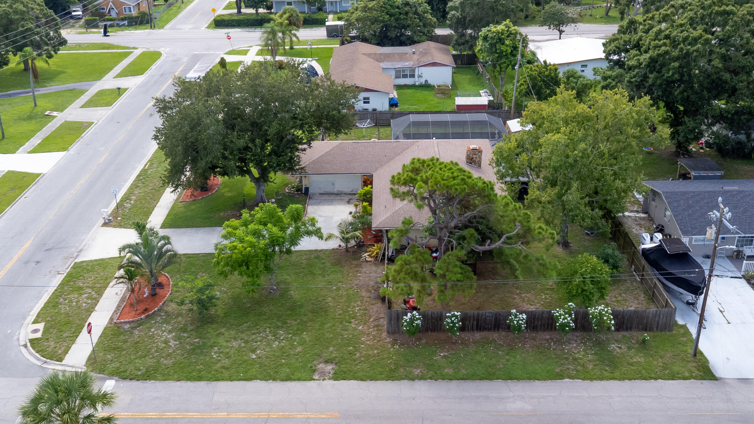 Welcome to this inviting 3 bedroom, 2 bath, pool home nestled on an expansive corner lot in beautiful Fort Pierce. With great bones and tons of potential, this home is ready for its next chapter - and with your little touch, it's truly move-in ready. Enjoy an open layout featuring a living area with double Fireplace, a functional kitchen with ample cabinet space. Step out into the backyard and enjoy the oversize pool with screened enclosure.Generously sized yard offers ample room for storing a boat, RV or toys. Additional features include a 2-car garage, mature landscaping & fruit tree. Location close to schools, shopping,dining and minutes to beaches.