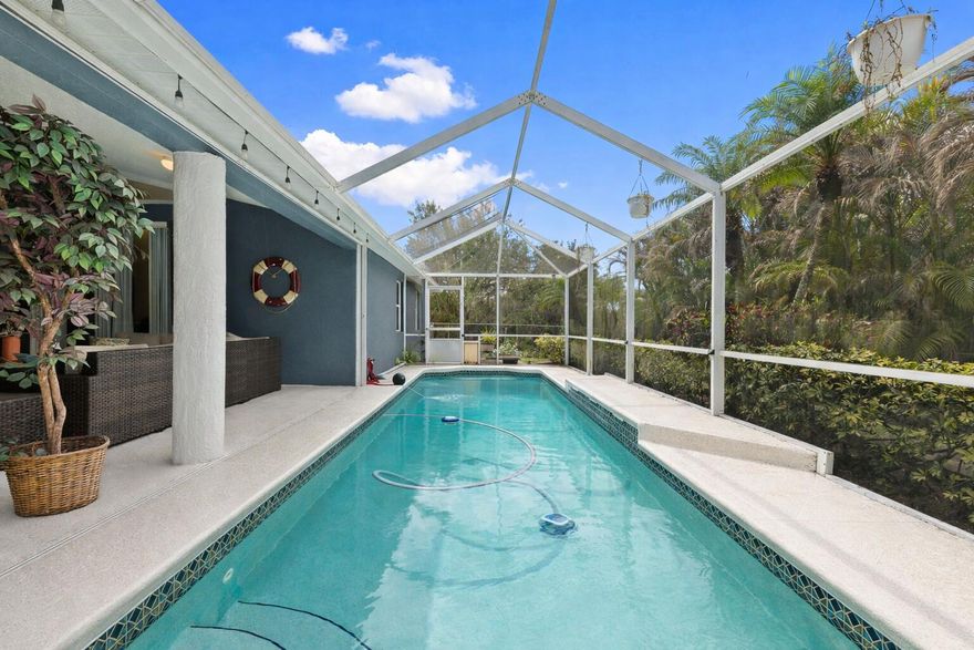 Welcome to this well-appointed 3-bedroom, 2-bathroom pool home offering an open, airy layout designed for comfortable Florida living. The kitchen shines with quartz countertops, soft-close cabinetry, stainless steel appliances, and a convenient pass-through window to the pool. Step outside to a spacious screened patio, with accordion shutters, a fully fenced yard, and mature areca palms that provide added privacy. With no HOA, vacant land next to the property, and no rear-facing neighbors, you'll enjoy a rare sense of space and seclusion. Take advantage of the short walk to Woodland Trails Park, while everyday conveniences like shopping, dining, and medical facilities are just minutes away. Commuters will appreciate quick access to both I-95 and the Florida Turnpike, placing this home in one of the area's fastest-growing corridors.