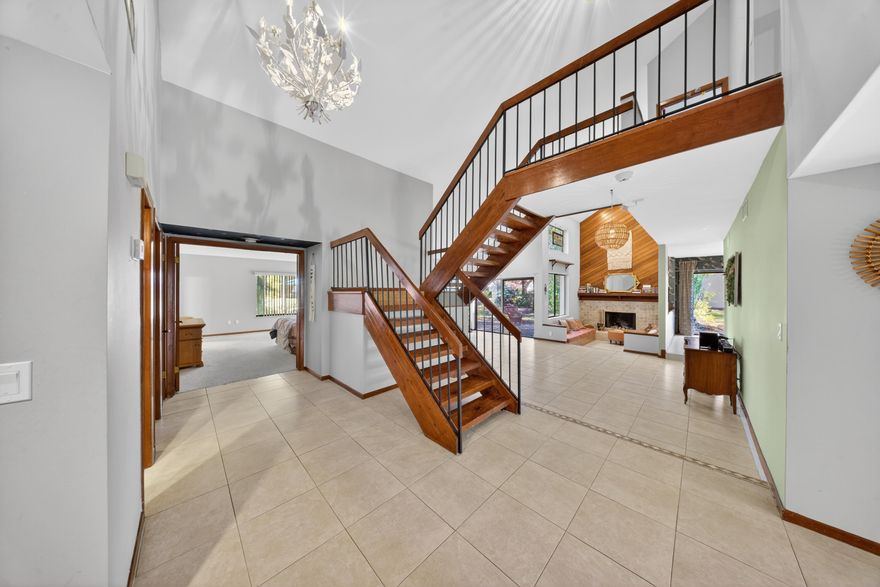 Spacious 4BR/3BA custom built home in desirable River's Edge on a .43-acre corner lot! Offering 3,089 living SF (4,339 total), this mid-century inspired residence features vaulted ceilings, a wood-burning fireplace, and a double door entry. Kitchen includes Corian countertops, stainless steel appliances, tiled backsplash, and recessed lighting. First-floor owner's suite with dual closets, double sinks, and walk-in shower. Upstairs offers two guest bedrooms with Jack & Jill bath. Metal roof, accordion storm shutters, and new electrical outlets/switches. Enjoy a screened lanai, open patio, porch pond, and mature landscaping. Close to shopping, golf, parks, and beaches!
