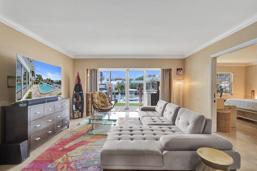 Experience the ultimate boater's lifestyle in this rare, ground floor 2/2 residence, featuring a 36' DOUBLE deeded dock on a wide canal - just off the Intracoastal Waterway. No fixed bridges and direct ocean access, in the highly desirable Coral Ridge neighborhood. Park both your boat and wave runners by your double dock and enjoy the unmatched convenience of stepping into your watercraft straight from your home. Enjoy water views or soak up the sun by the heated pool - waterfront living at its finest, at an unmatched price point. Located in an intimate 12-unit boutique community just minutes from Fort Lauderdale Beach, this first-floor unit offers effortless indoor-outdoor living. Inside, beautiful marble tile flooring flows throughout the spacious living areas. A bright, air-conditioned and fully enclosed sunroom provides an ideal space to unwind after a day on the water. The community has recently undergone significant enhancements, including a refreshed exterior, lush tropical landscaping, and a beautifully renovated heated pool finished with elegant travertine pavers—creating a true resort-style atmosphere. Offering both comfort and confidence, this well-managed two-story community has strong reserves and has successfully passed all milestone inspections.  The 36' double deeded dock, due to its positioning is ideal for accommodating a 36' vessel PLUS additional watercraft (like wave runners), with the option to install pilings.  2 large storage spaces outside of the unit provide extra space for all your water toys and fishing gear.  Zoned for the Bayview school district and just a short walk from pristine beaches, world-class dining, and vibrant shopping, this property perfectly blends relaxed coastal living with everyday convenience. A rare opportunity to own a slice of waterfront paradise—where boating, luxury, and location come together seamlessly.