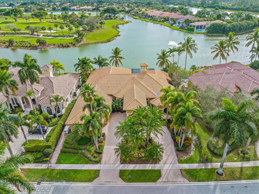 With one of the BEST WATER and GOLF lots in all of Ibis, this former ''Street of Dreams,'' Hawk's Landing model home boasts incredible upgrades and updates, inside and out. The dramatic Porte Cochere and three-car side-entry garage welcomes you to this custom estate. With a bright Southern exposure in the rear of the home, this 4BR/4.5BA+Den+Sitting Room estate boasts a picture-window screened enclosure, custom designed to enhance the dramatic way the INFINITY EDGE pool seems to vanish into the lake. Enjoy incomparable sunset views from the heated pool and spa, the large outdoor kitchen, all enclosed by a state-of-the-art screened enclosure that maximizes the dramatic infinity edge!