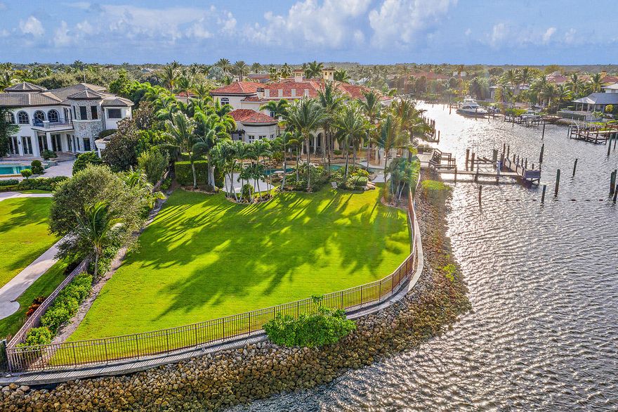 Location Location Location! A BOATERS DREAM - Point Intracoastal lot in Prestigious Admirals Cove.  This property has almost 300' of water frontage, (see survey in documents) and is a one of a kind property.  Dockage on the canal for a 85+ boat, plus 2 additional boat lifts.  New roof in 2019, and freshly painted interior.  This smart home has a room for everything, wine room, theater, office, golf range, chefs kitchen, guest wings ... you name it, it has it.  Enjoy countless hours outside by the resort style pool, outdoor bar and summer kitchen, covered loggias and one of the largest lots in Admirals Cove.