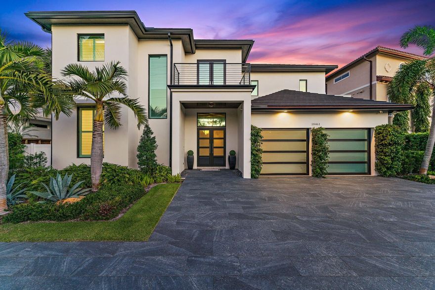 Perched on the aqua waters of Jupiter, this 4-bed, 4.5-bath contemporary home is a private retreat with impressive Intracoastal and preserve views. Entertain guests in the open-format chef's kitchen and living space, lined at the rear with conjoining windows and sliding doors that connect the interior with the lush outdoor landscape. Take the elevator to the second floor to view the master suite, additional bedrooms and terrace overlooking the Intracoastal. The covered patio and outdoor kitchen adjoin the saltwater pool, hot tub and dock - a prime spot for boating and located close to the inlet for ocean access. With a porcelain tile driveway, updated roof & recently-installed windows (2019), and concrete construction, this luxury property is well-maintained and in impeccable condition.