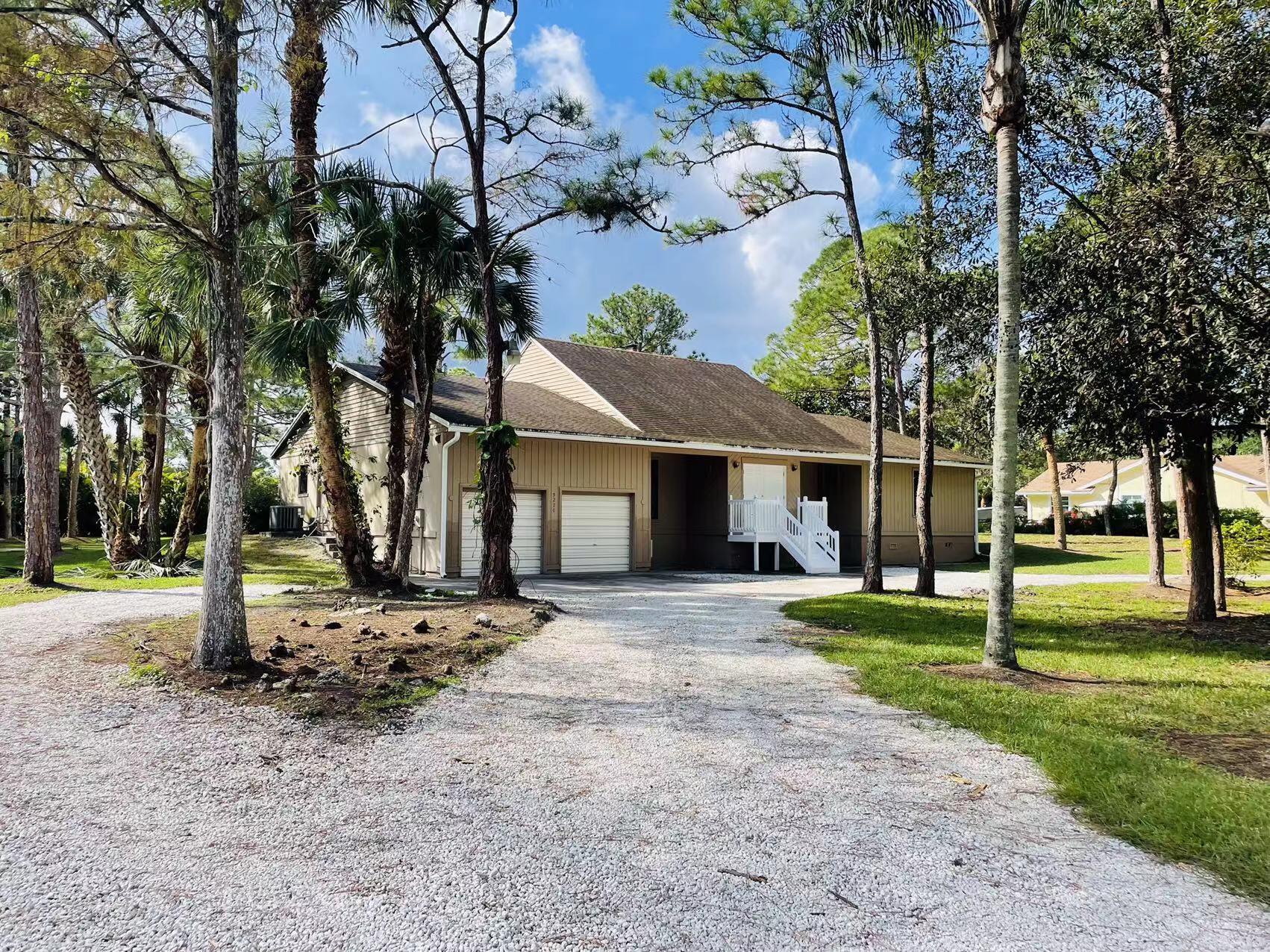 A gorgeous, remodeled and furnished fully in Jupiter Farms single level home! This home is on the improved street, no dirt road. Elegant Kitchen with white countertop. 12 ceiling lights and ceiling fans in spacious living room. Primary bathroom with stylish input items. All toilets are were replaced with new ones less than a year ago. Each room has its fan to make air circulation better. This is 4-bedroom home. The landscaping work is done well, cleaned the yard and pond. A circle driveway is plus for this big house, driveway has gravel.