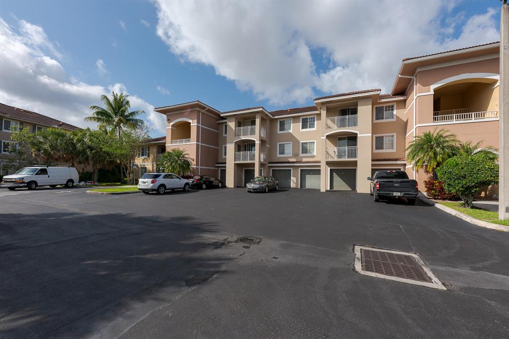RARE TURN KEY OPPORTUNITY! Offered fully furnished, this one bed, one bath, 2nd floor condo with garden views in a gated community checks all the boxes. Property includes a deeded 1-car garage AND covered carport. Gourmet kitchen features new appliances and new washer in the laundry room. Large covered patio. Spacious primary bedroom with walk-in closet. CBS construction with hurricane resistant windows and sliding doors. Excellent opportunity for a starter home or 2nd home for weekend get aways. Community features 2 clubhouses, 2 fitness centers, 2 Olympic size pools with bbq areas, 2 whirlpool spas, business center, party room, game rooms, yoga room, tennis and putting green. Minutes to downtown West Palm Beach, Beaches, Shopping, and Airports.