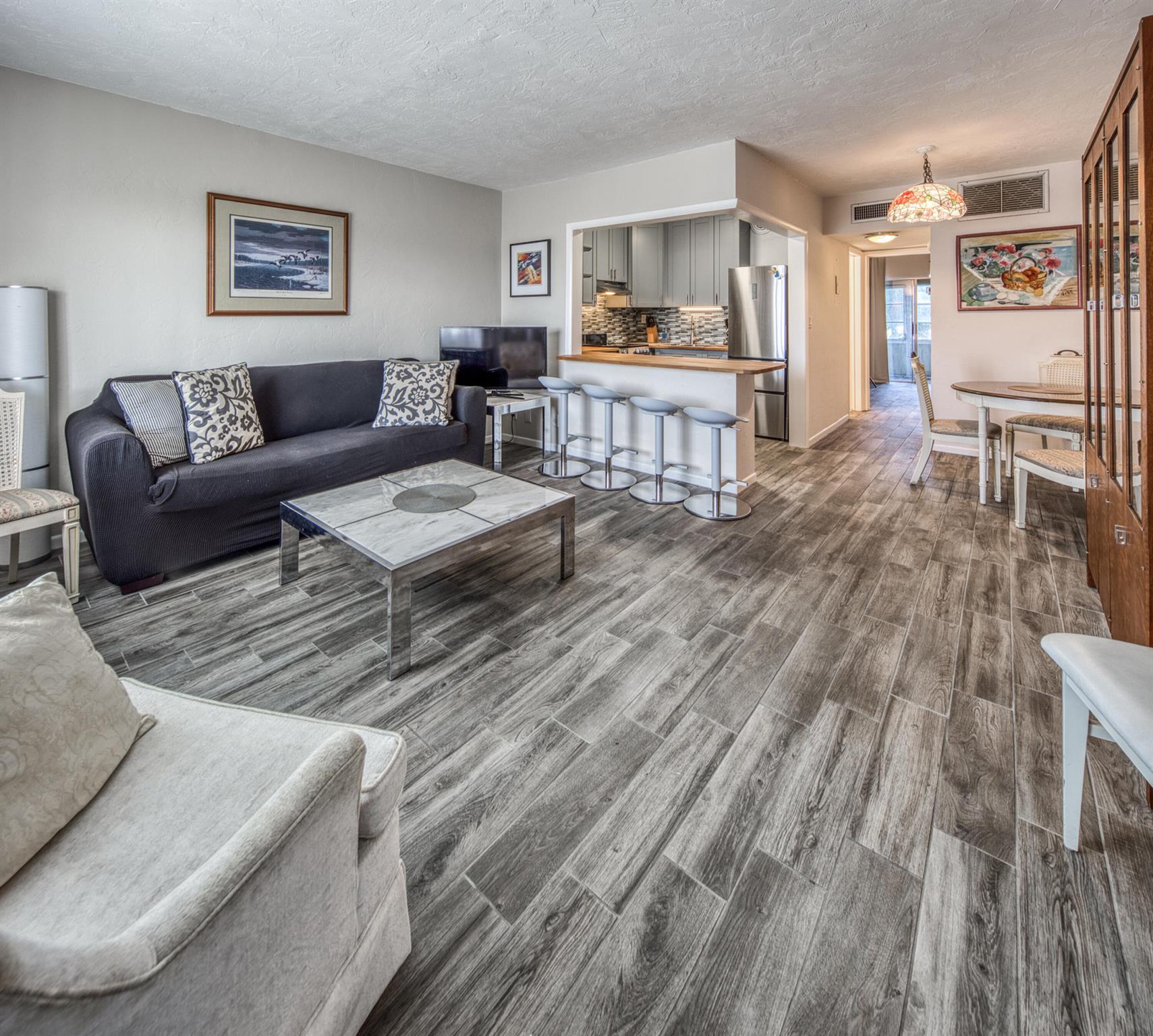 Very bright and cozy 1 bedroom, 1 bathroom apartment on the shores of Lake Osborne. The apartment was renovated in 2018, when the kitchen cabinets, appliances and counter tops were renewed and the kitchen opened beautifully into the living room. The floors replaced throughout the apartment and balcony with elegant light gray porcelain tiles. Also added new bathroom cabinets, sink and mirror and water heater.This 55+ community apartment is located in a well-maintained condo building where the Milestone inspection has been done in 2022. Incredibly beautiful outdoor areas for walking and cycling around Lake Osborne.