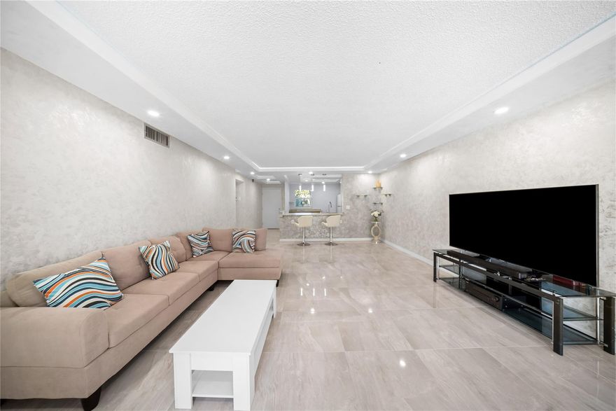 Stunning, Fully Renovated 2 Bed, 2 Bath Corner Unit - Priced To Sell In This Highly Desirable 55+ Community. This Bright, Airy Condo Offers An Open Layout Filled With Natural Light. The Modern Open-Concept Kitchen Features Sleek White Cabinetry, Brand-New Appliances & Elegant Porcelain Tile Flooring. Freshly Painted Venetian-Finish Walls & A Drop-Down Ceiling With New LED Lighting Create A Refined Living Space. Both Bathrooms Are Fully Updated With Porcelain Tile Flooring & Glass Sliding Shower Doors. Additional Highlights Include Impact Windows, A Screened-In Porch & Central A/C & Heating. Resort-Style Amenities Include Pools, Pickleball, Fitness Center & A Vibrant Clubhouse. Move-In Ready & An Exceptional Value - Don’t Miss This Opportunity!