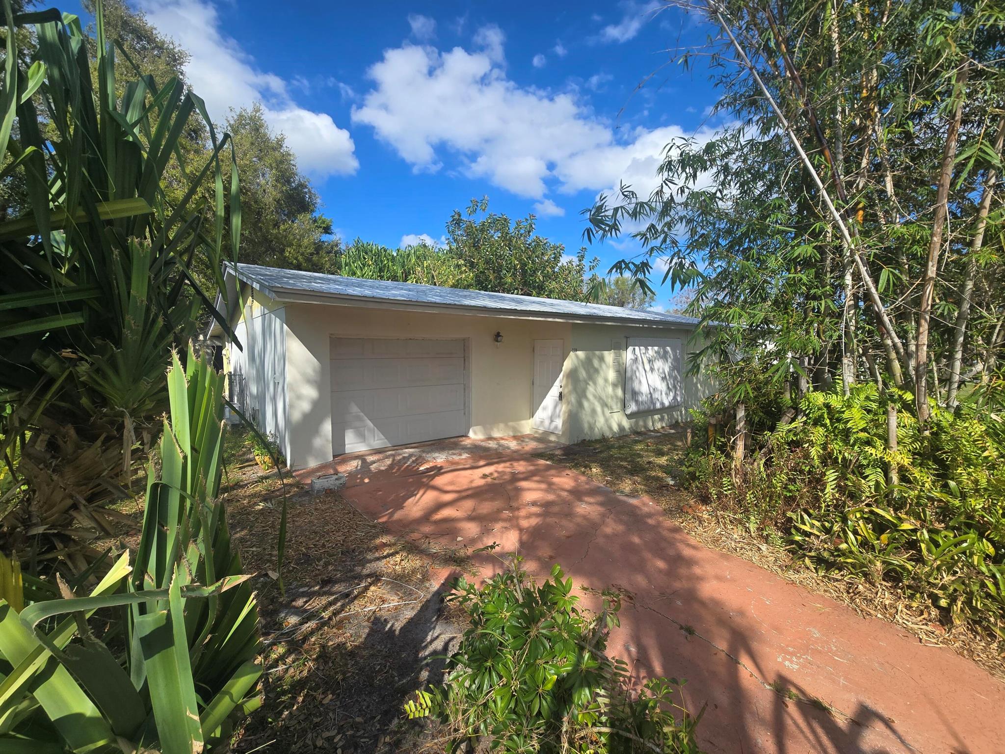 Excellent Opportunity to rehab this 2/1/1 in Beau Rivage East in Jensen Beach. No HOA fees or restrictions. 2018 Metal Roof. Impact Glass throughout in 2018. Sliders from the dining area bring you onto the Glassed-in patio is permitted and adds 180 sq ft of air conditioned living / entertaining space. Property needs kitchen cabinets and appliances. Additional open air patio area.