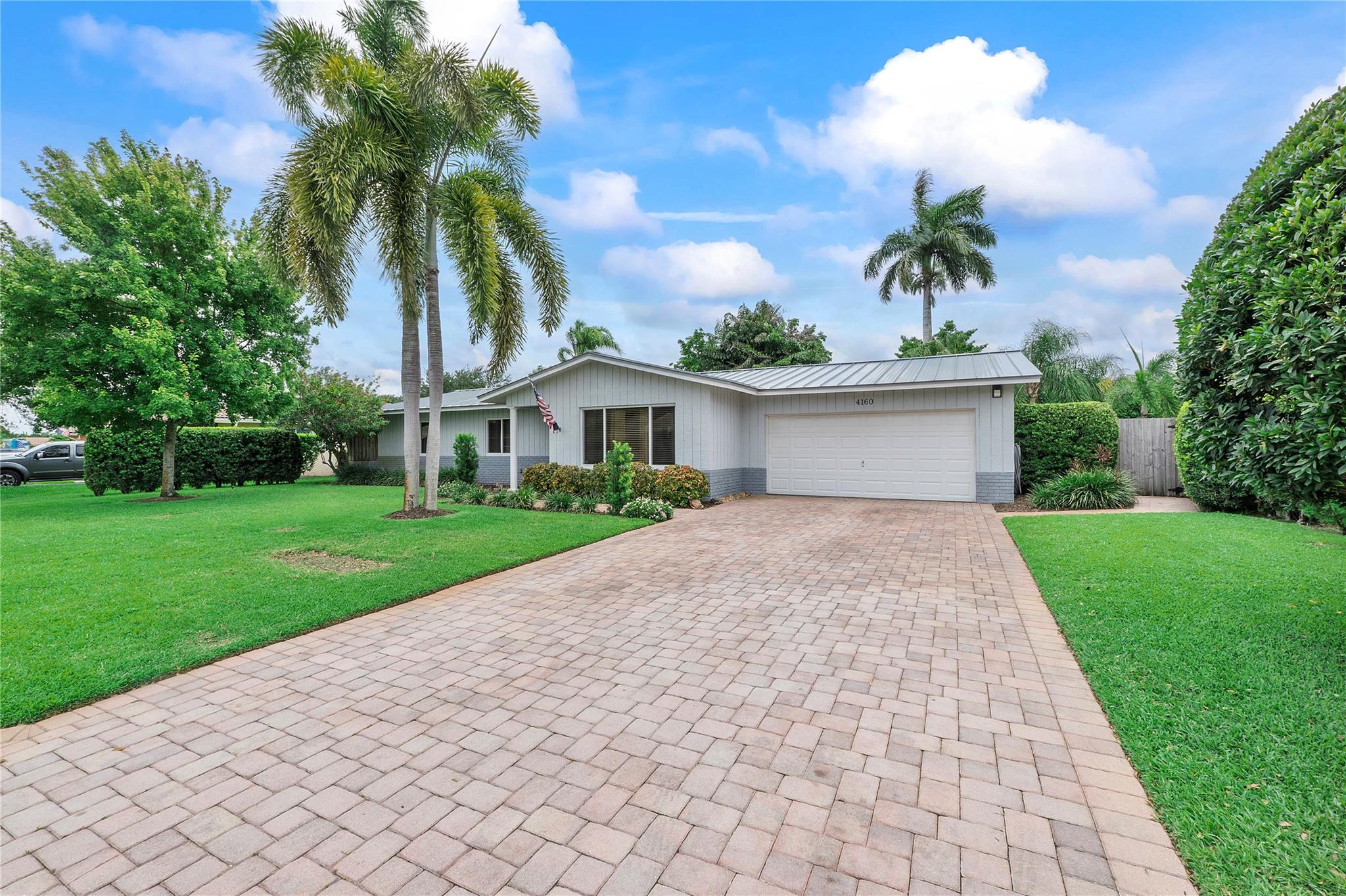 NEW METAL ROOF 2024 AND IMPACT WINDOWS ON THIS OUTSTANDING HOME!! THIS METICULOUSLY MAINTAINED AND BEAUTIFULLY UPDATED HOME SITS ON A GORGEOUS PARK LIKE OVERSIZED LOT WITH A VERY PRIVATE FENCED BACK YARD. OTHER FEATURES INCLUDE GREAT CURB APPEAL, A PAVER DRIVEWAY, A WONDERFUL NEW KITCHEN WITH QUARTZ COUNTERS & NEWER STAINLESS APPLIANCES & FARM SINK, A/C 2019, UPDATED PRIMARY BATH, ELECTRIC PANEL 2023, REAL WOOD & PORCELAIN TILE FLOORS, CUSTOM CROWN MOLDING, A/C IN THE GARAGE FOR THOSE THAT ARE HANDY, AND A BEAUTIFUL FRONT DOOR. BIG INSIDE UTILITY ROOM TOO. MR. AND MRS. CLEAN LIVE HERE...THIS ONE IS IN MOVE IN READY CONDITION. GREAT LOCATION TOO SITUATED ON A LOVELY CULDESAC STREET CLOSE TO SCHOOLS AND SHOPPING AND EASY ACCESS TO THE SAWGRASS EXPRESSWAY. NO HOA TOO!